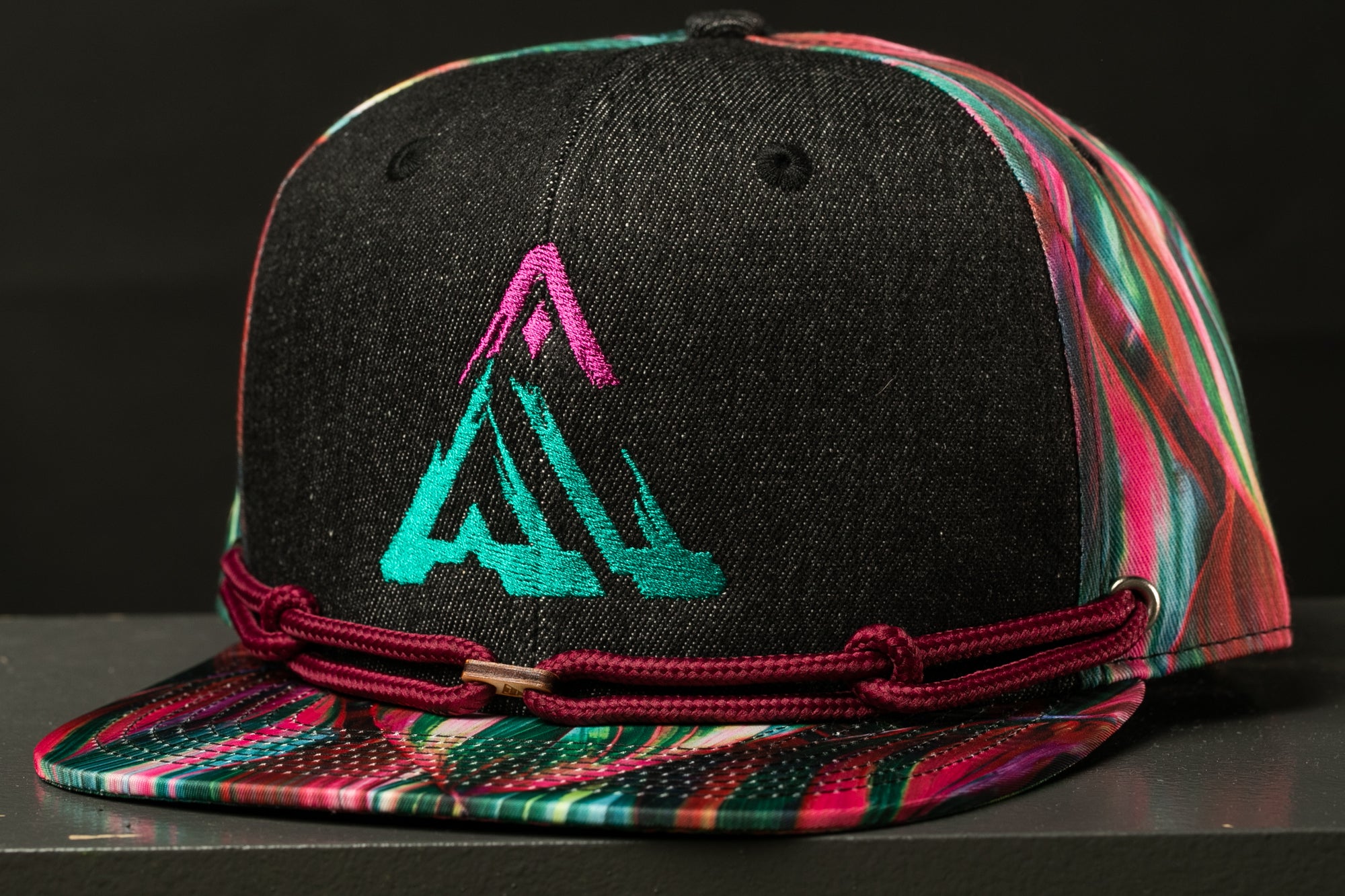A colorful, patterned baseball cap with a graphic design on the front.