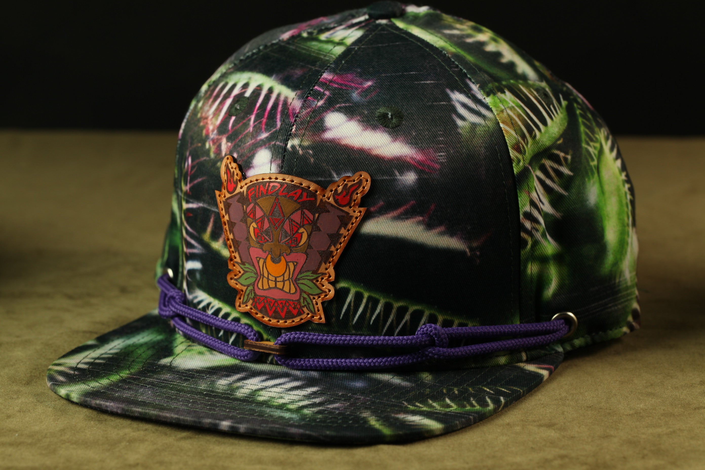 A colorful, patterned baseball cap with a distinctive logo on the front.