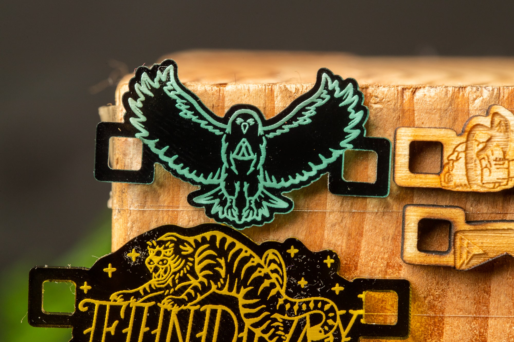 a close-up view of a wooden surface with various decorative elements, including a bird, a tiger, and other intricate designs.
