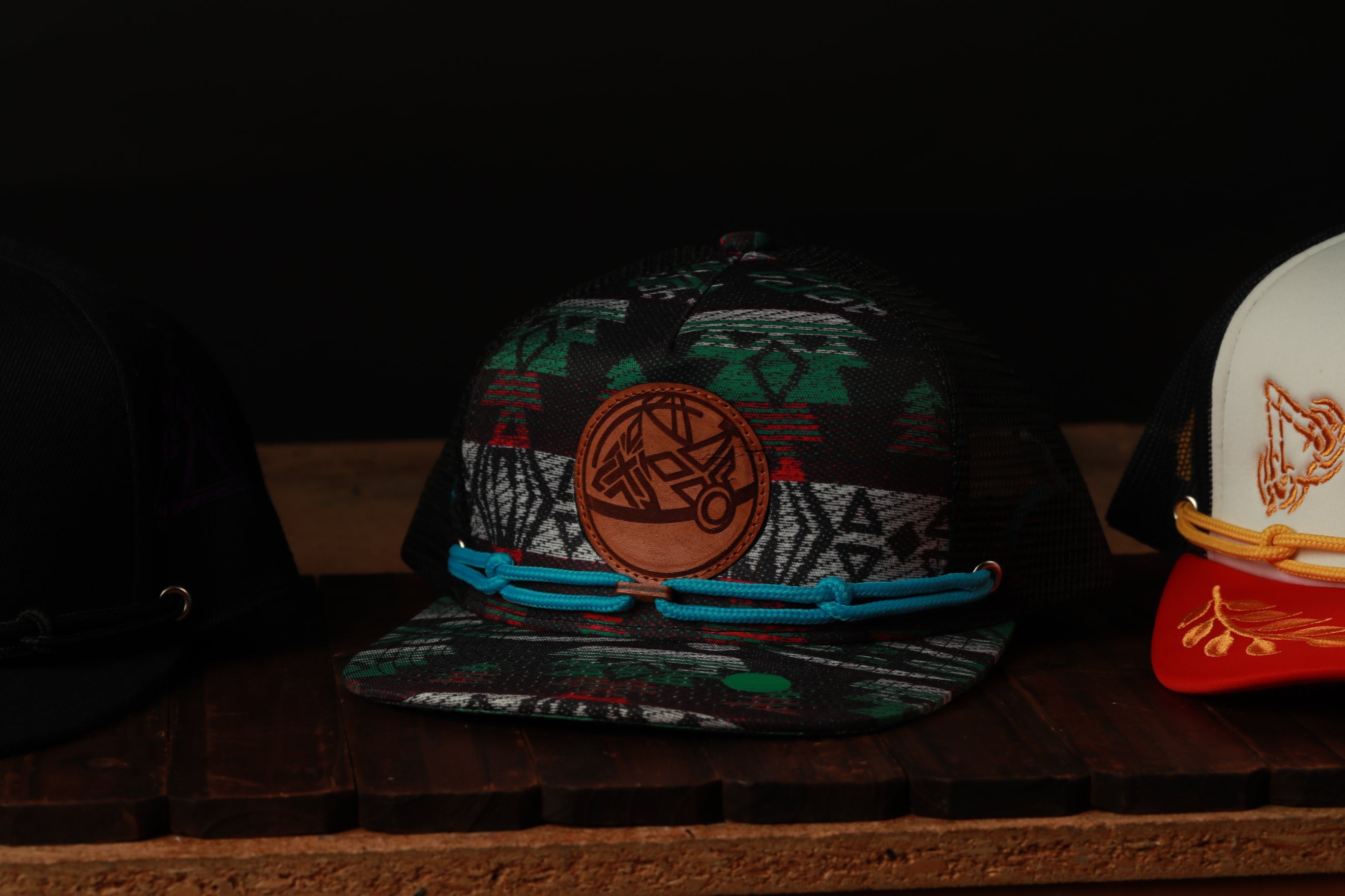 A collection of colorful baseball caps displayed on a wooden surface.