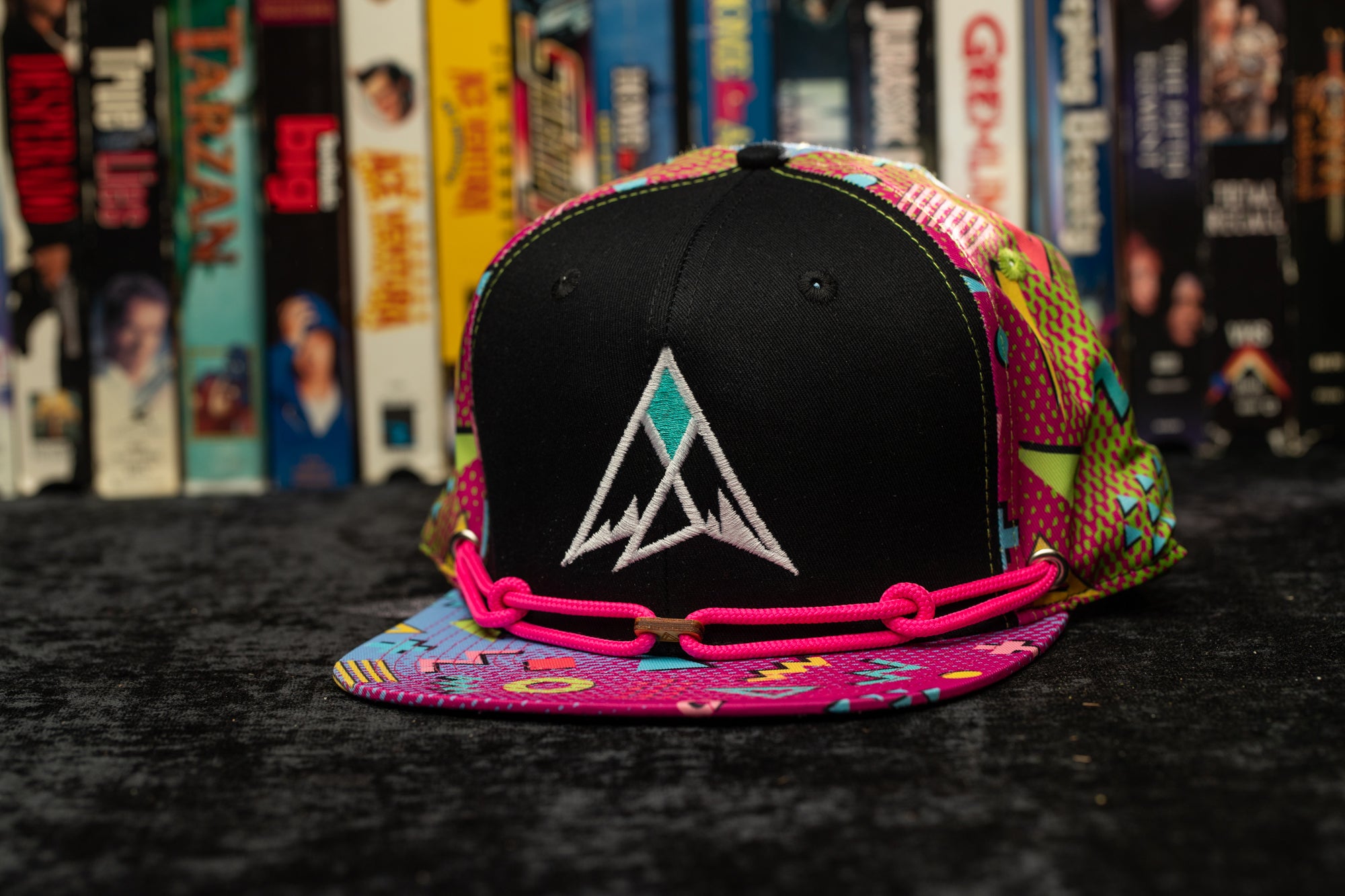 a black hat with a colorful triangle on it