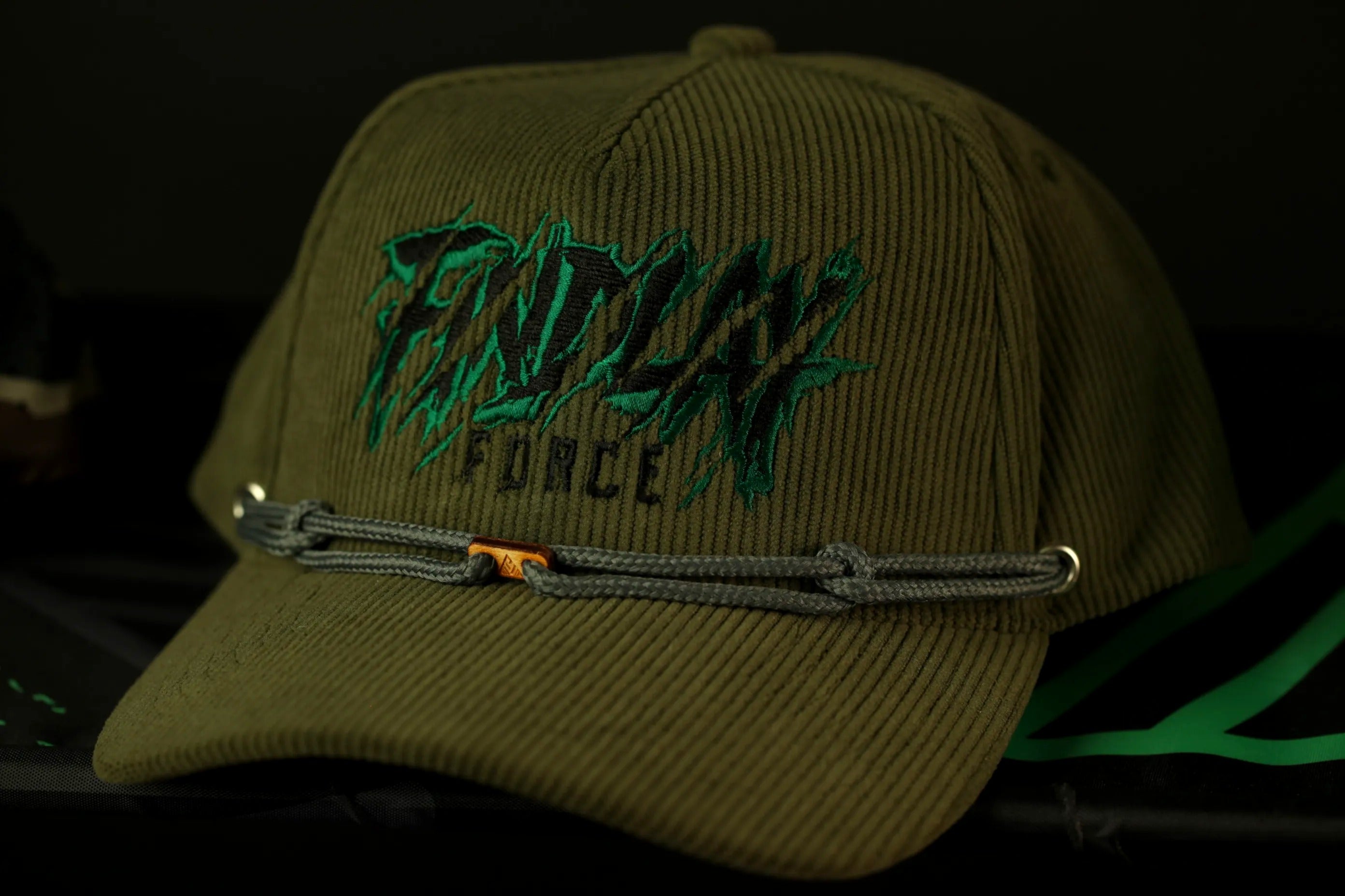 A green baseball cap with the text "FINDLAY FORCE" printed on it.