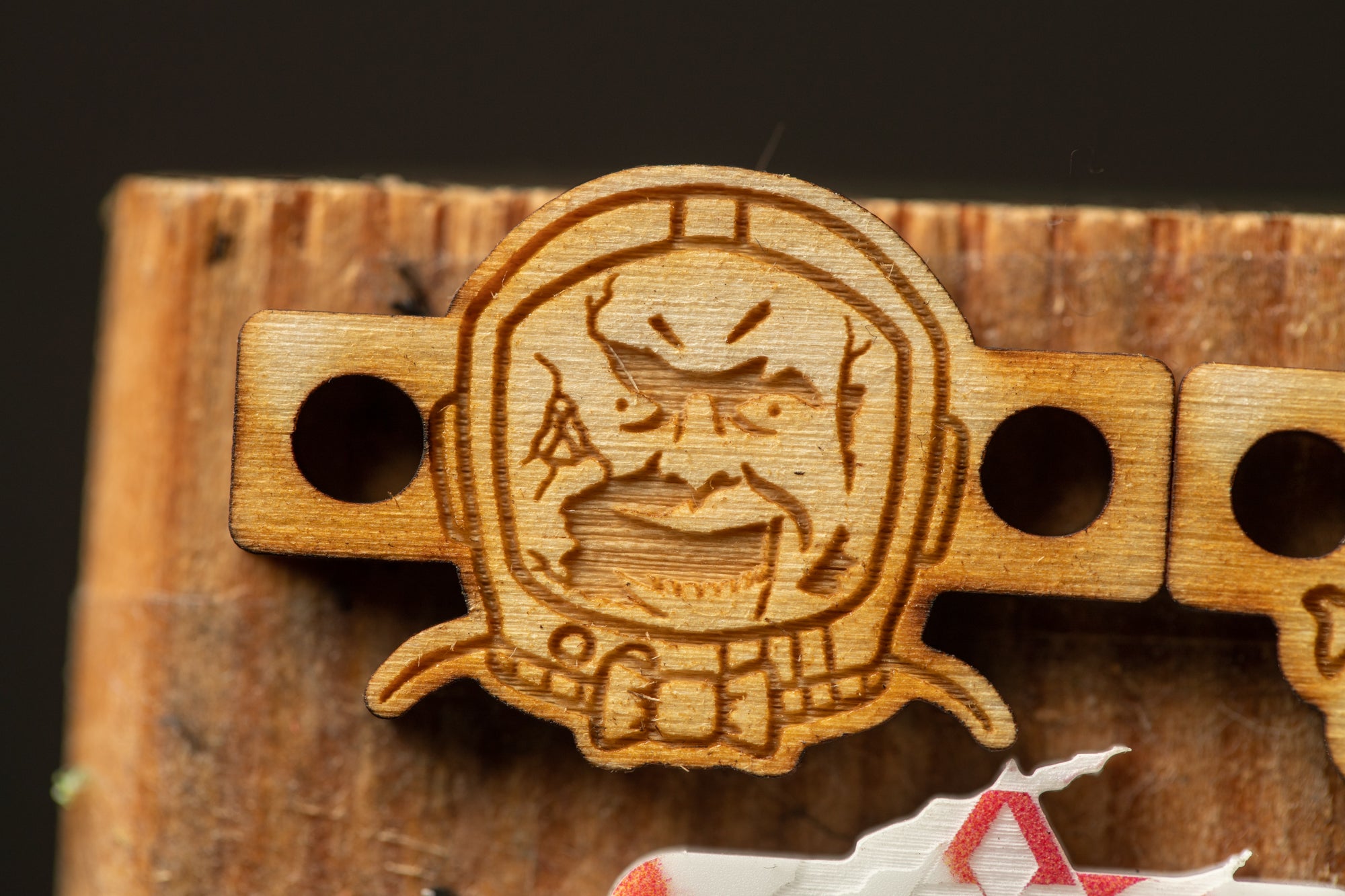 a wooden object with a carved face, possibly a piece of art or a decorative item.