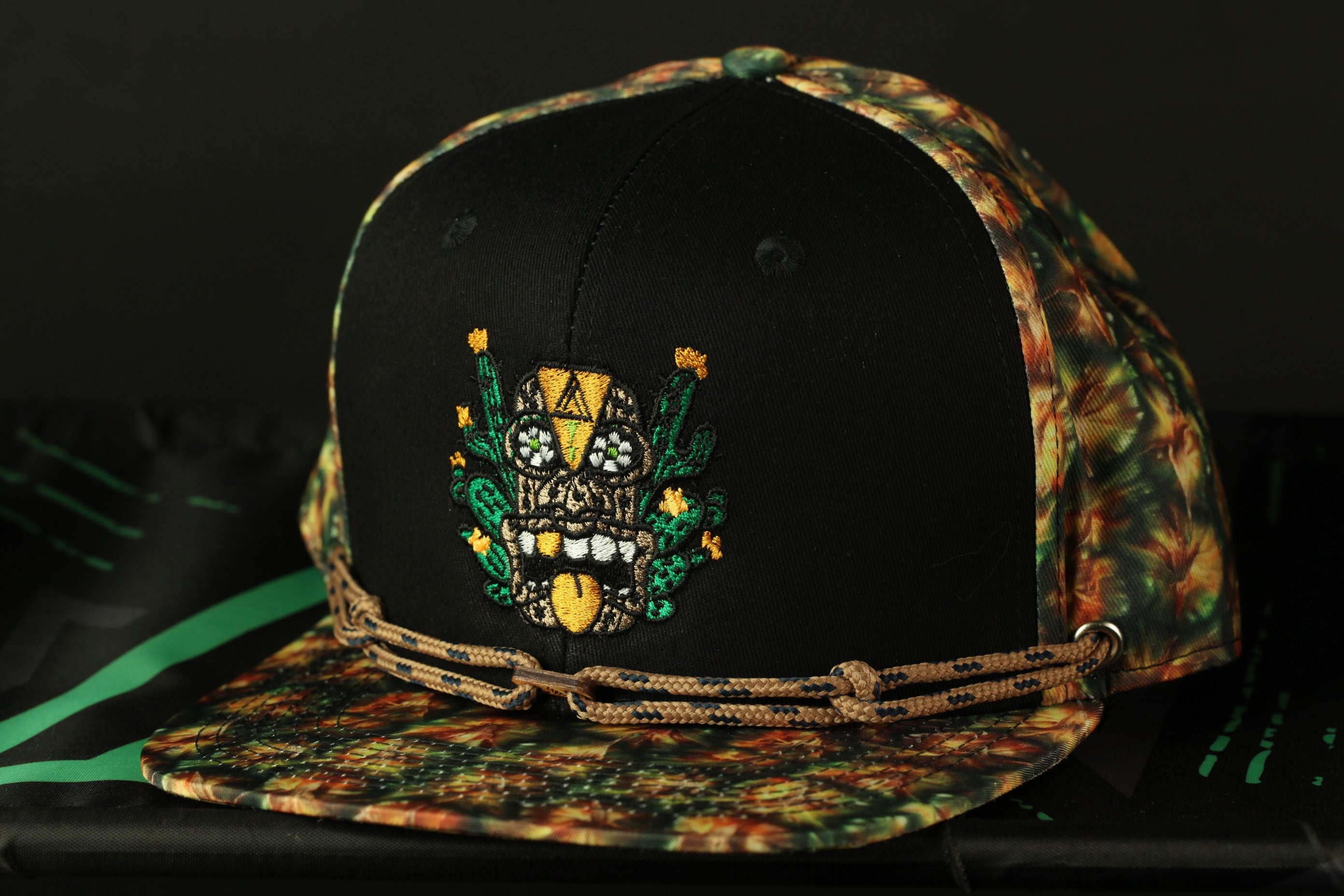 A colorful baseball cap with a black brim and a floral pattern on the front.