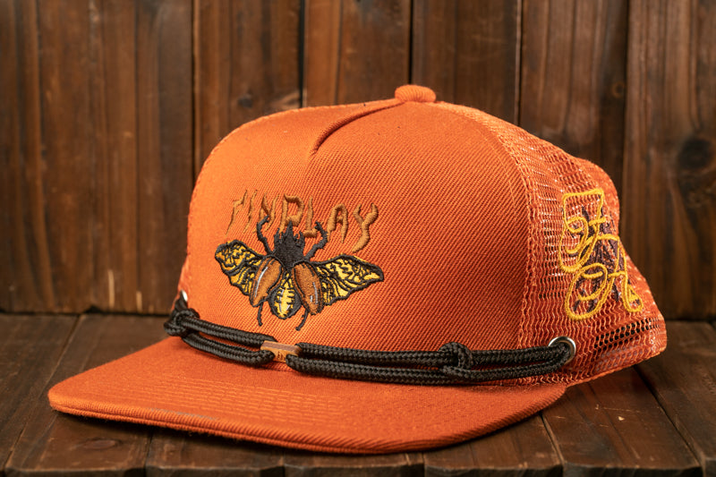 An orange baseball cap with a mesh back and a black strap, featuring an embroidered design of a butterfly on the front.