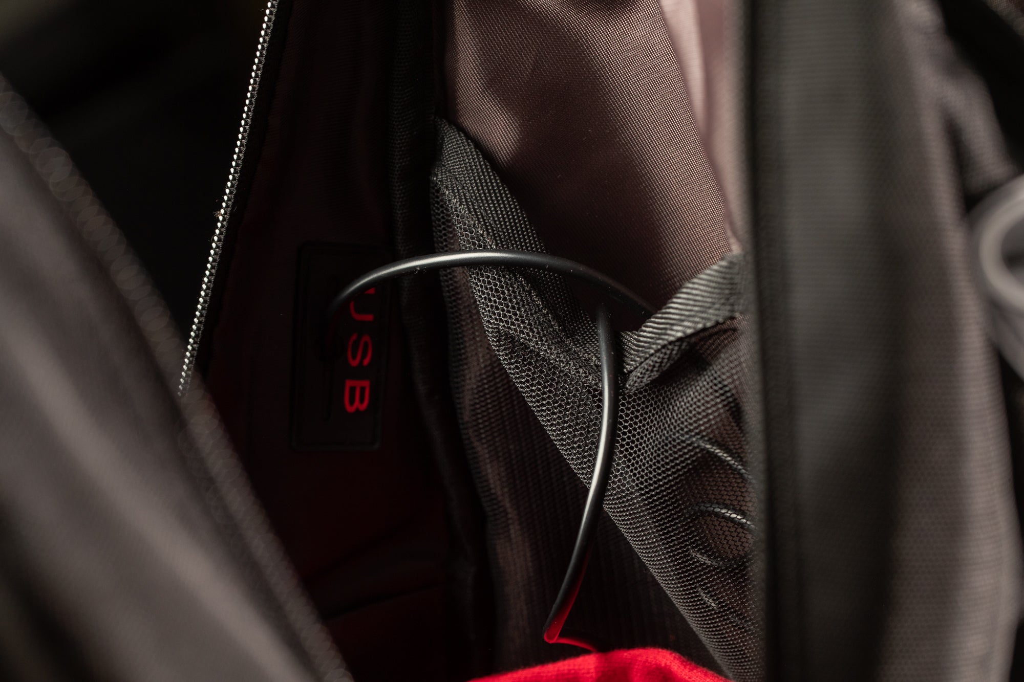 a close-up view of a black bag with a USB cable visible inside.