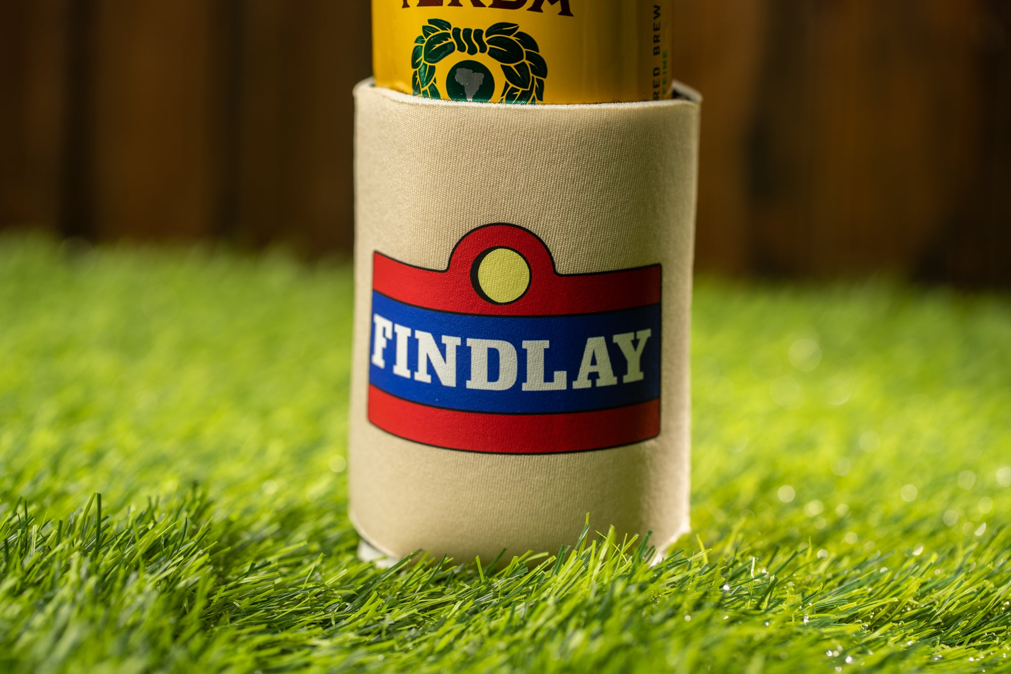 A close-up image of a foam cup with a label that says "FINDLAY" on it, placed on a grassy surface.