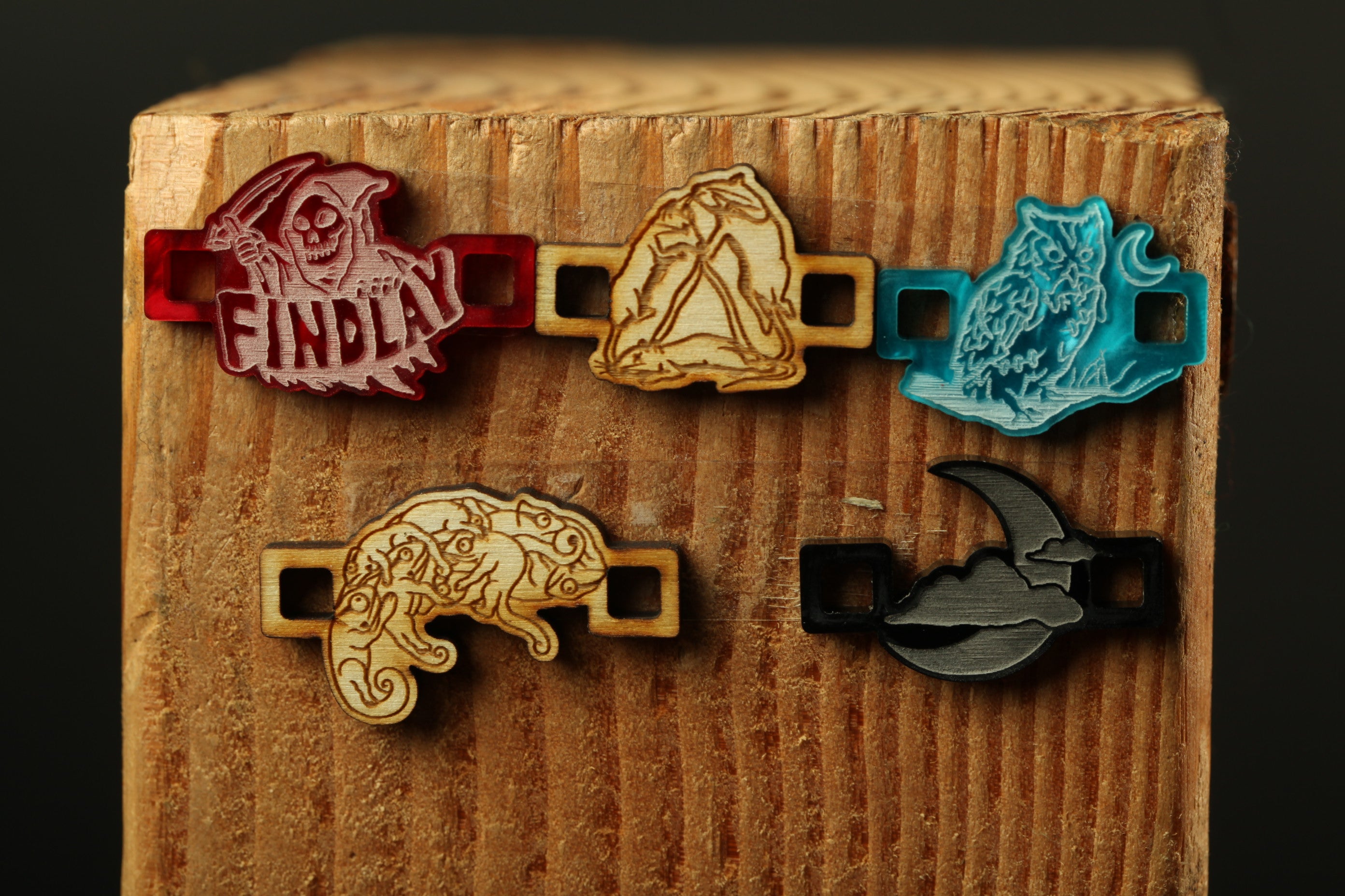 a wooden surface with five unique wooden objects, each with a distinct design and color.