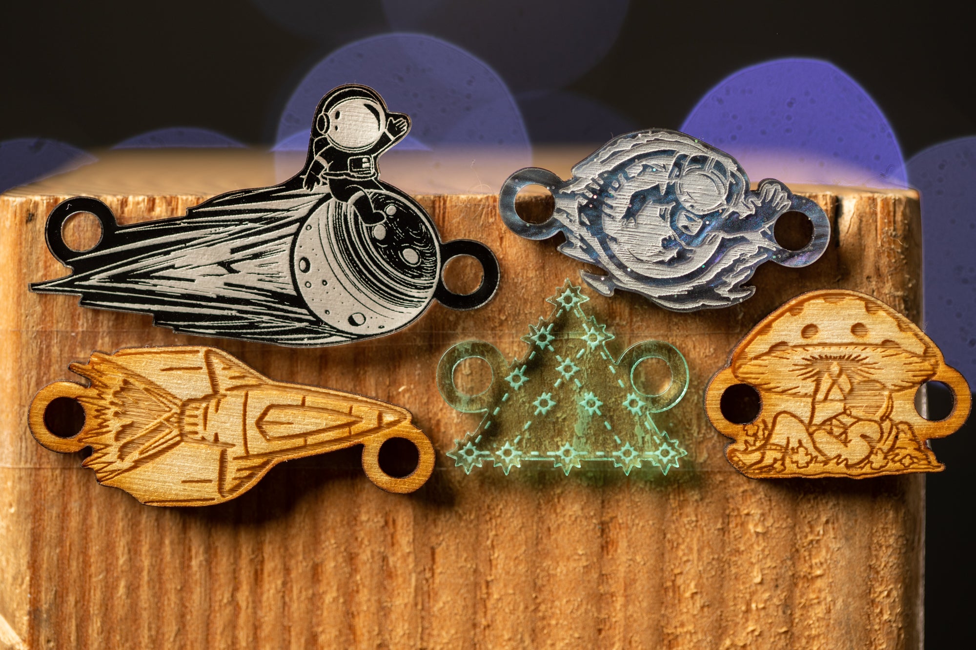 a wooden surface with various engraved objects, including a rocket ship, a mushroom, a triangle, and a person.
