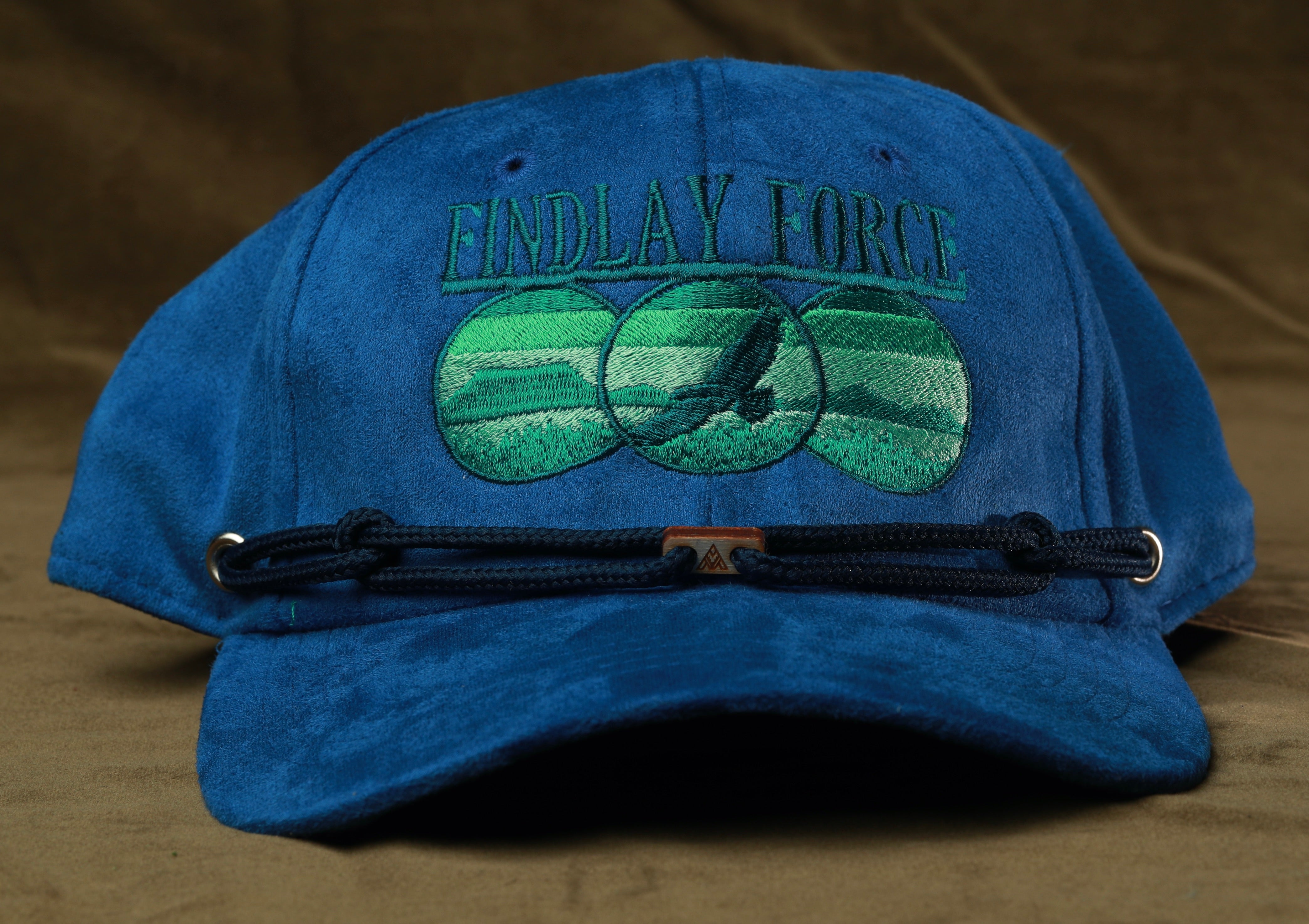 A blue baseball cap with the text "FINDLAY FORCE" and a graphic of a bird in flight on the front.