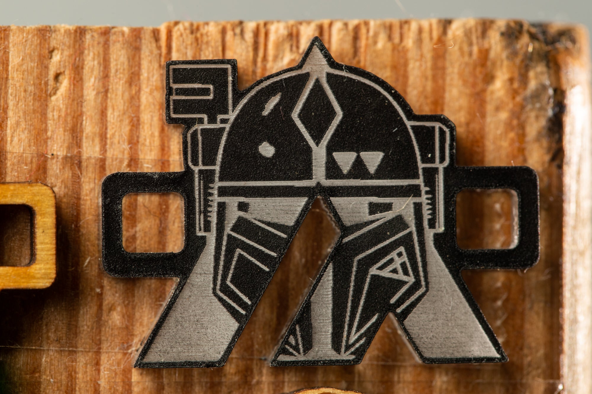 a close-up view of a black and white geometric pattern on a wooden surface.