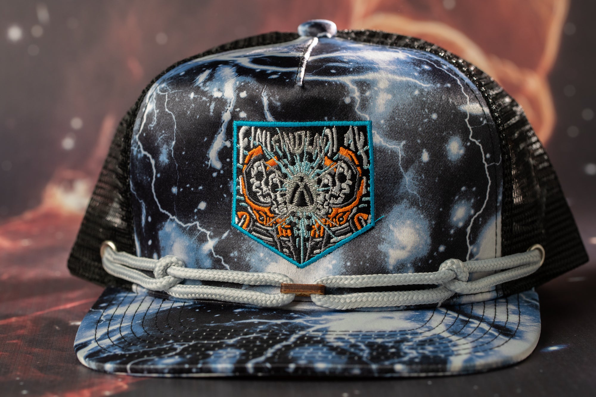 A black and white baseball cap with a colorful, abstract design on the front.