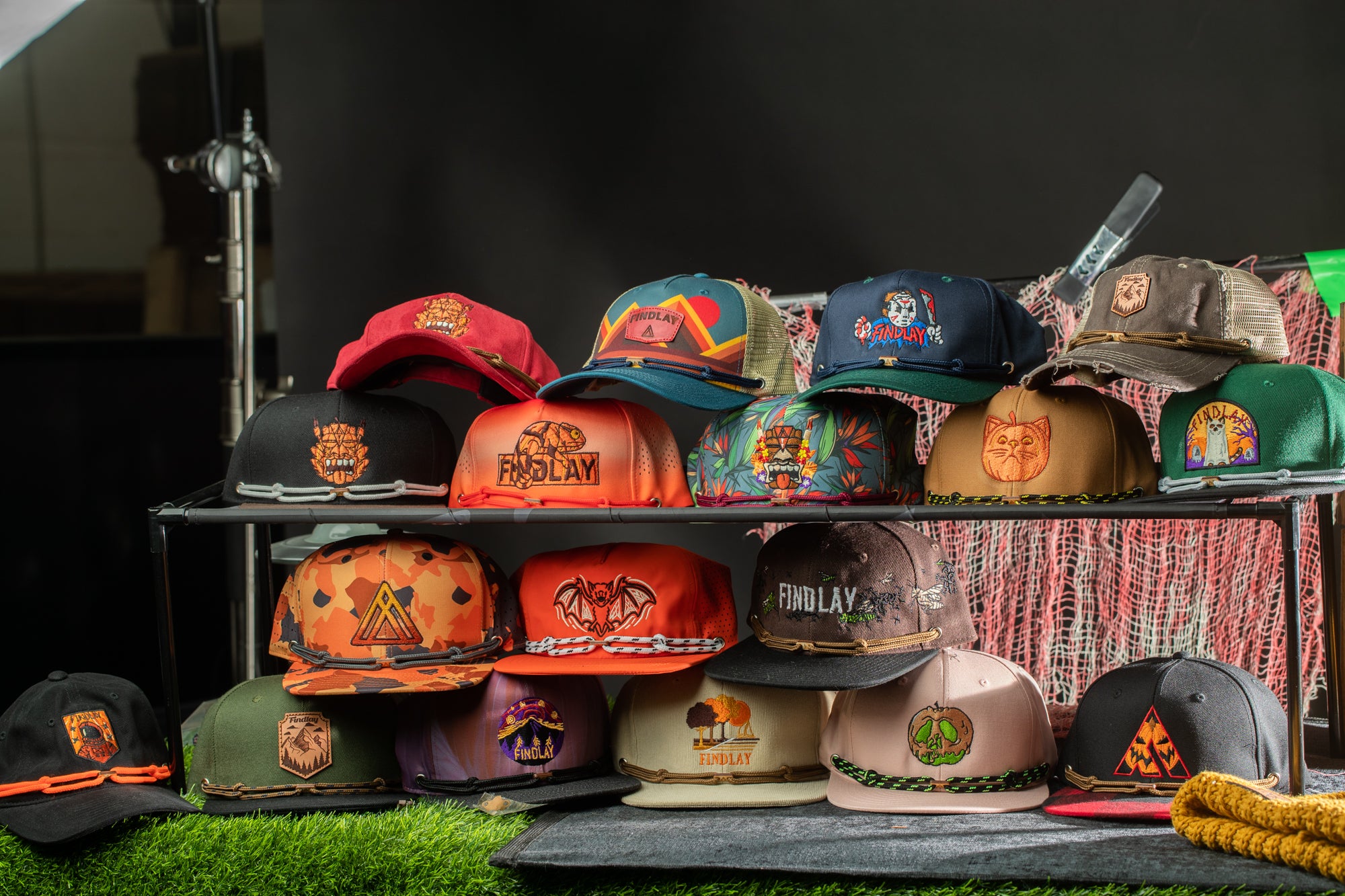 A collection of colorful baseball caps displayed on a shelf, with various designs and patterns.