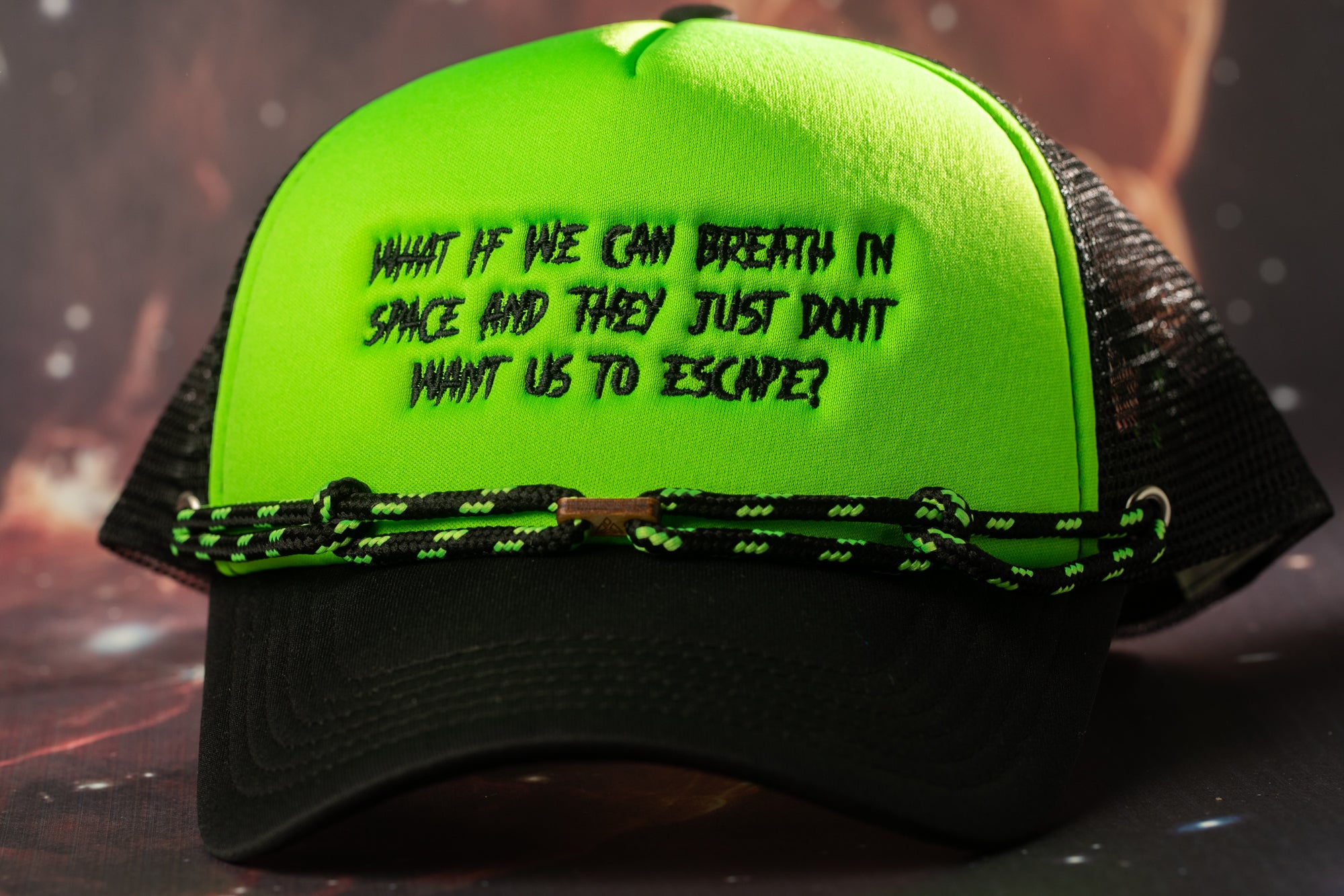 A bright green baseball cap with black text on it.