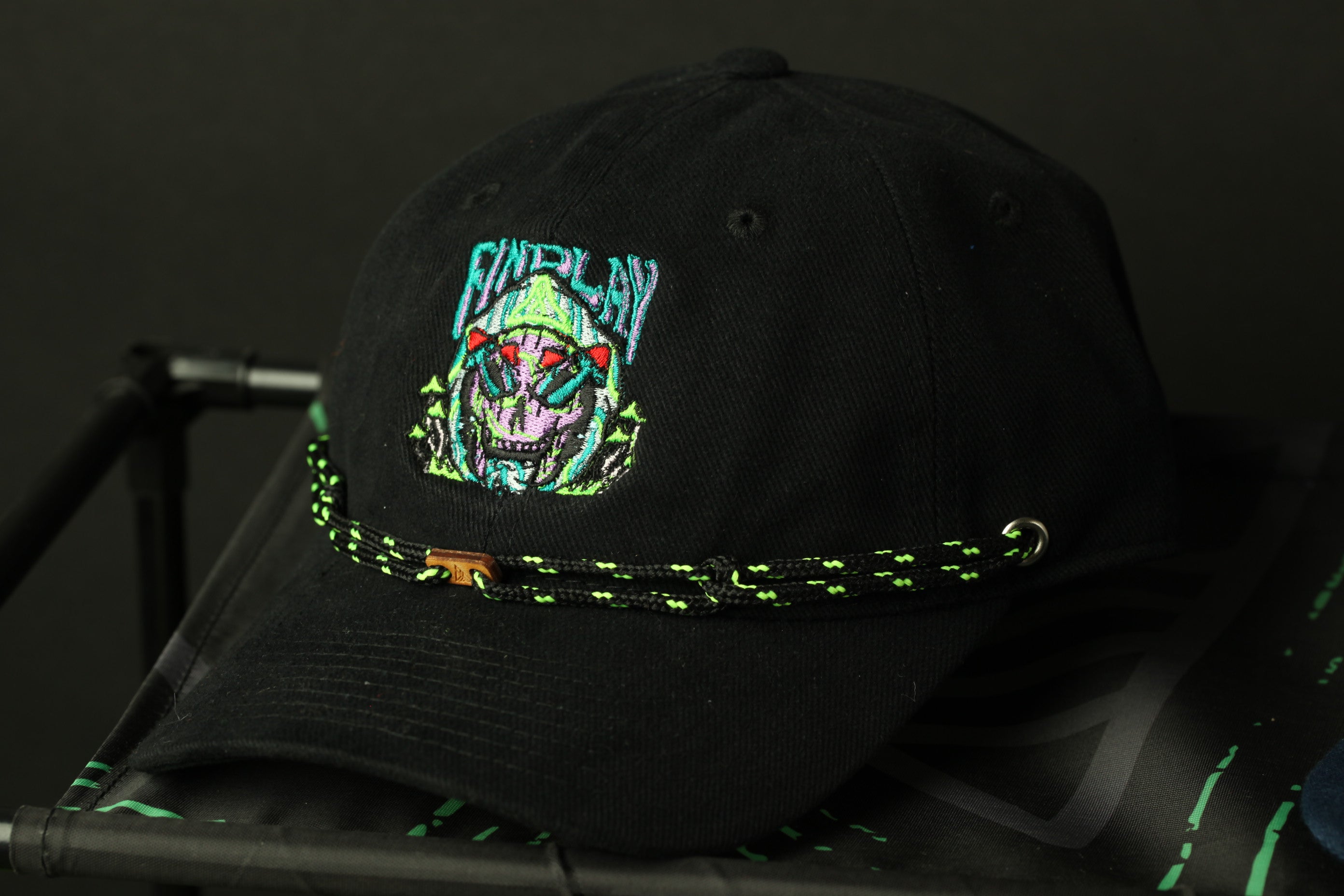 A black baseball cap with a colorful, graphic design on the front.