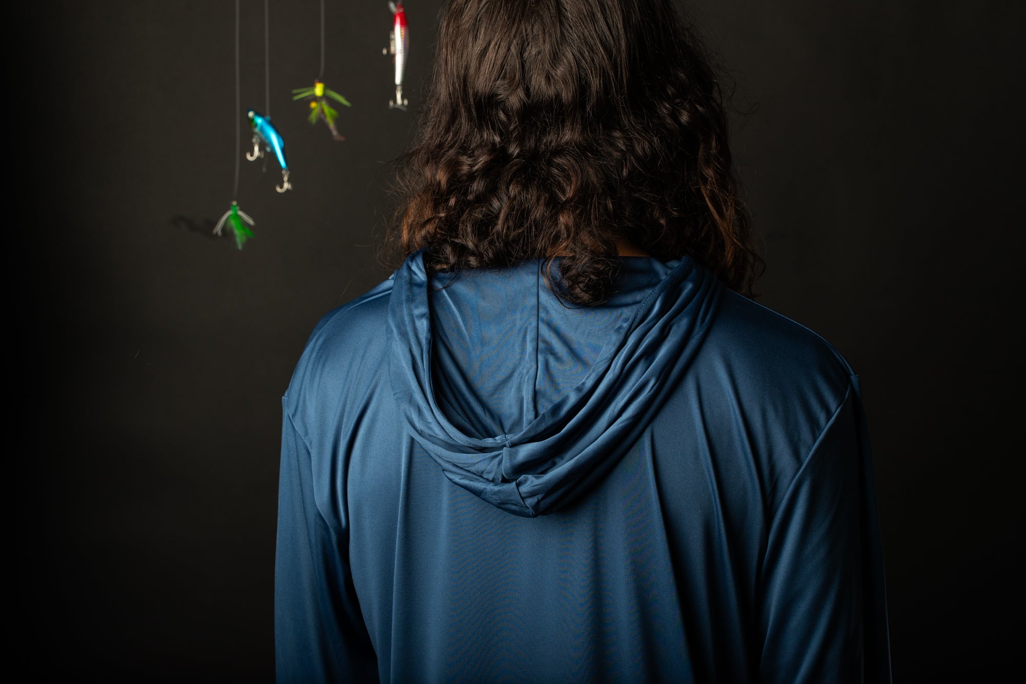 a woman standing in front of a mobile with birds hanging from it