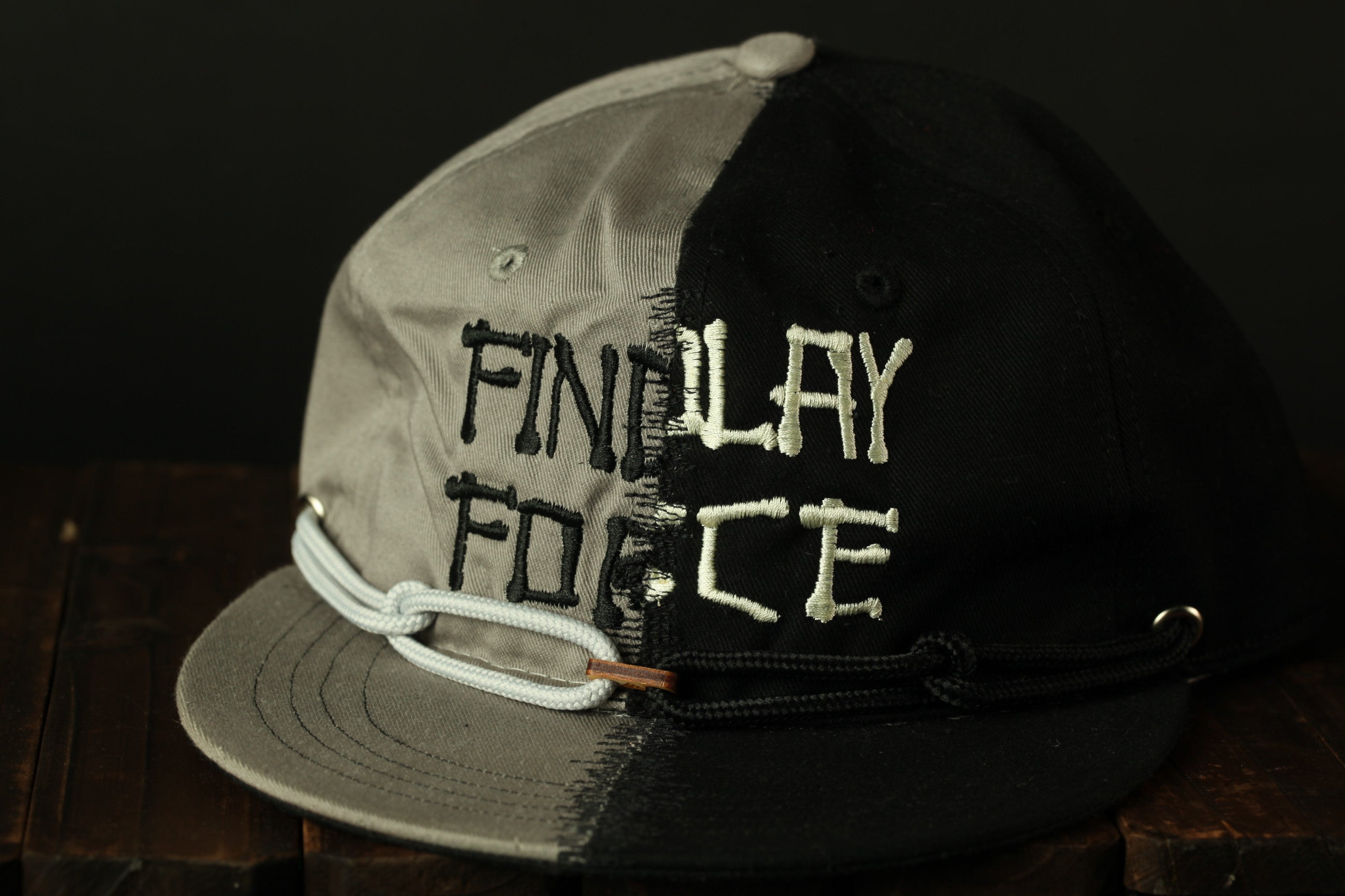 A black and gray baseball cap with the text "FINALLY FORCE" printed on it.