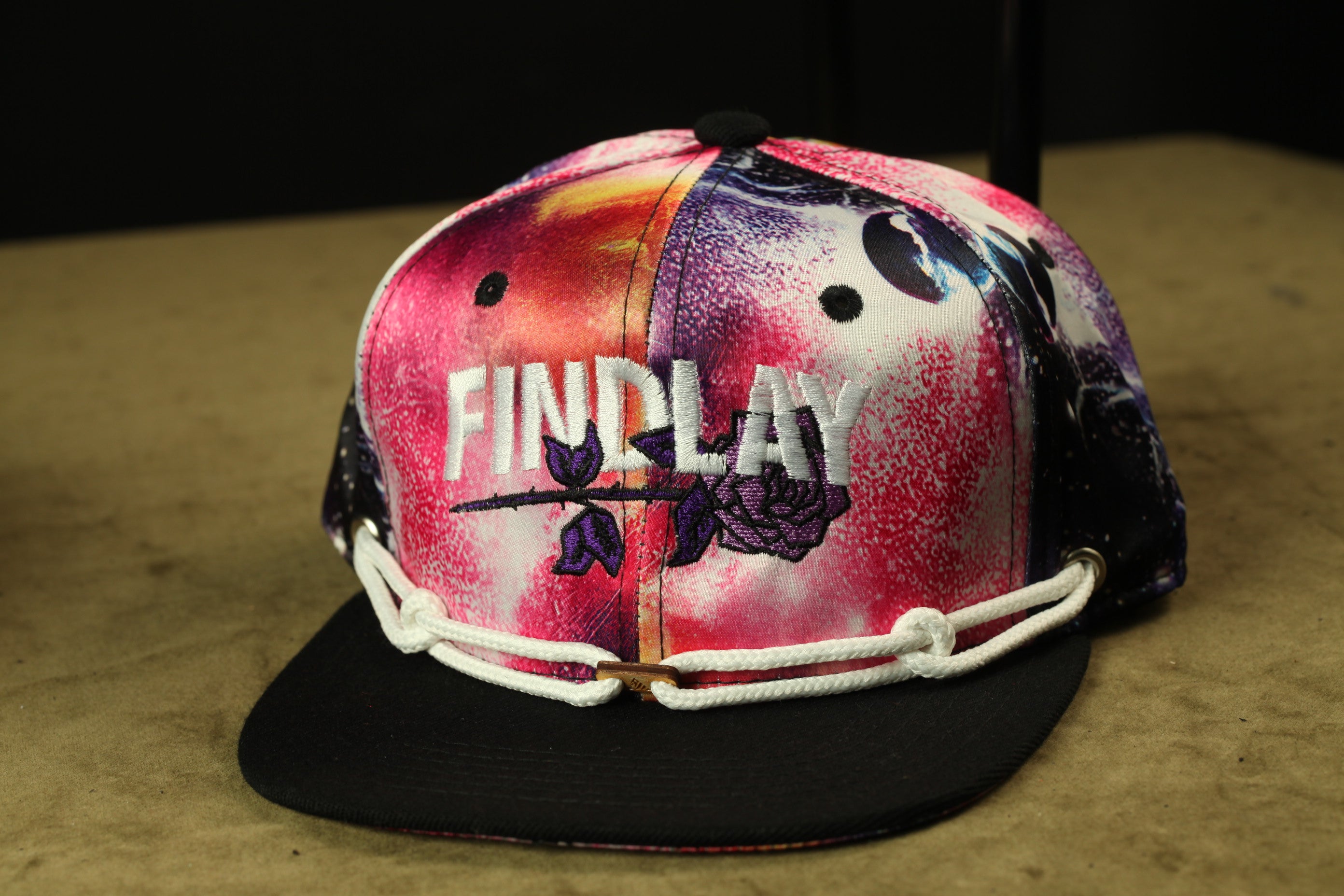 A colorful, patterned baseball cap with the word "FINDlay" printed on it.