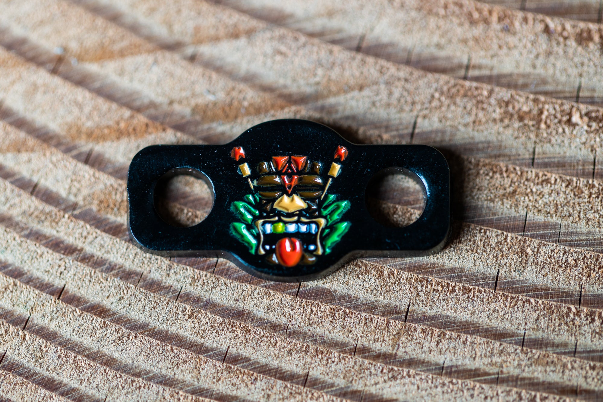 a close up of a black object on a wooden surface