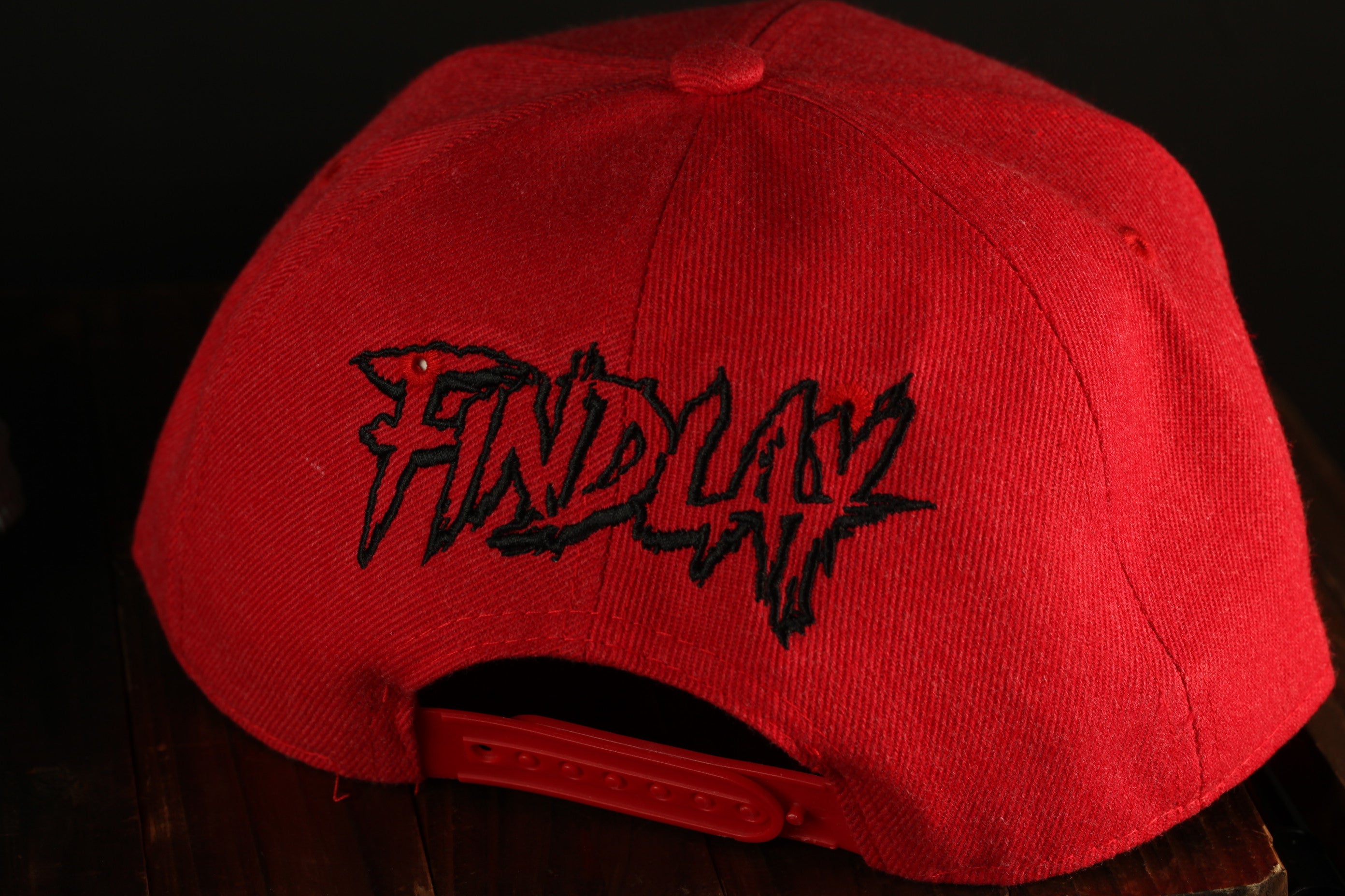 A red baseball cap with the word "FIND" printed on it.