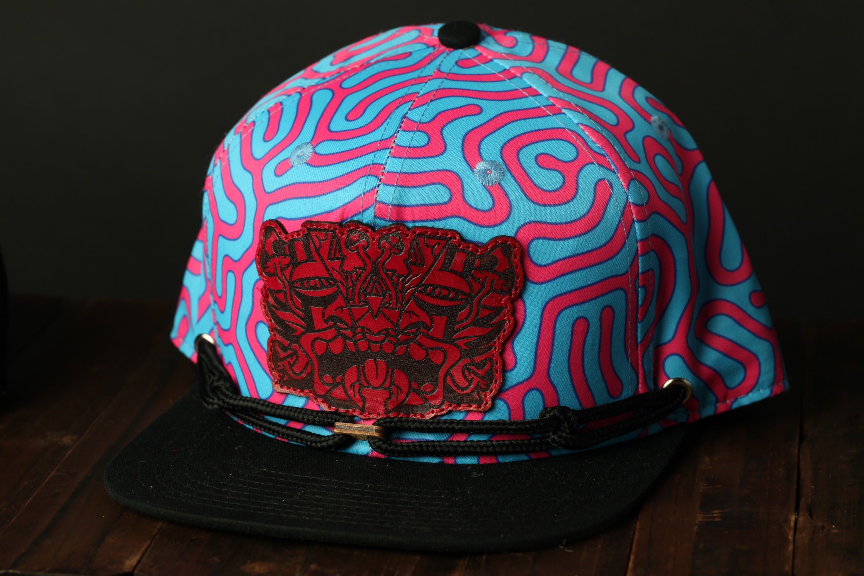 A colorful, patterned baseball cap with a distinctive design on the front.