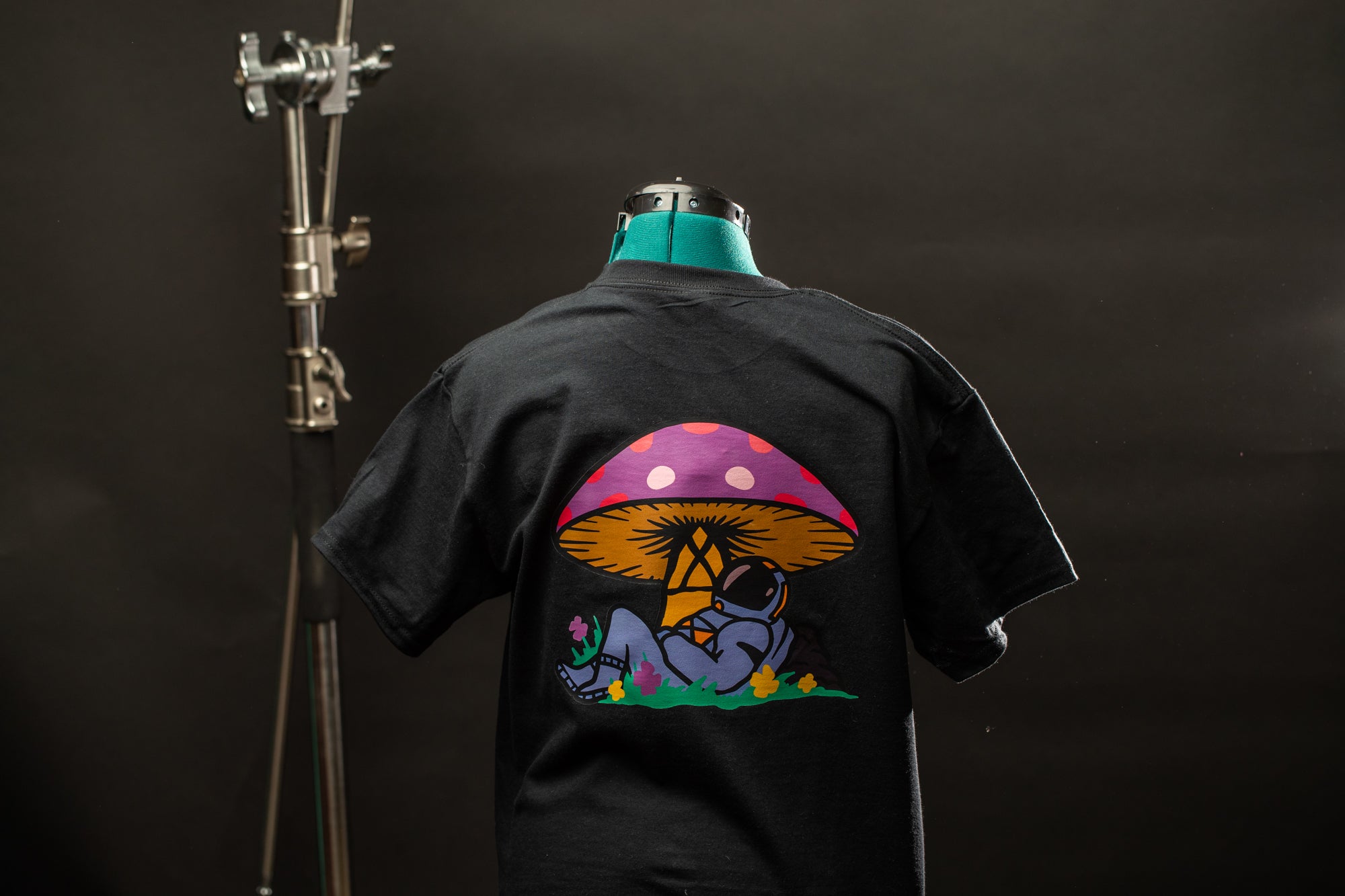 a black shirt with a mushroom on it