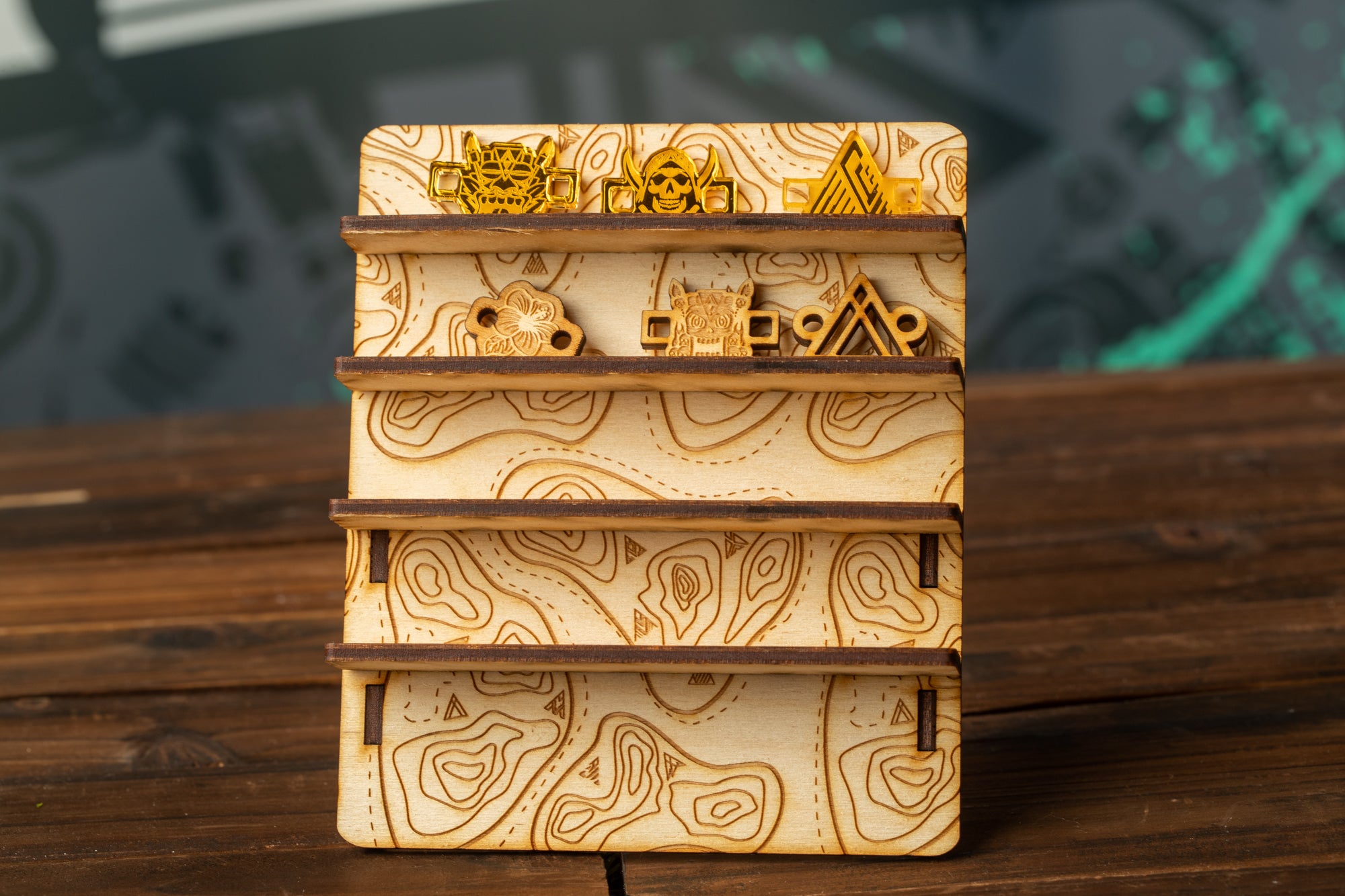 A wooden display stand with three shelves, each containing a unique design or object. The stand has a wooden surface with a patterned design, and the objects on the shelves appear to be small and decorative.