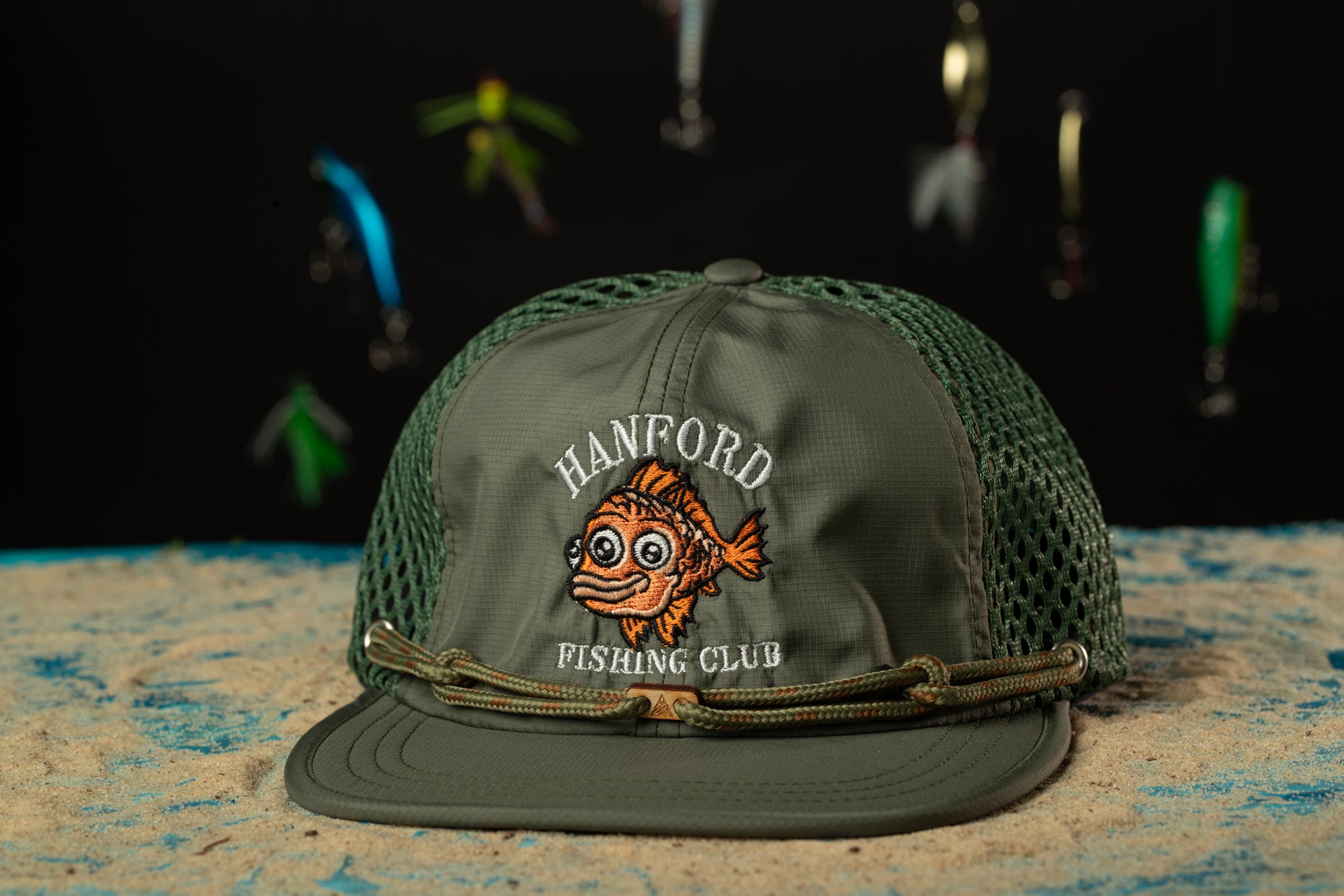a green hat with a fish on it