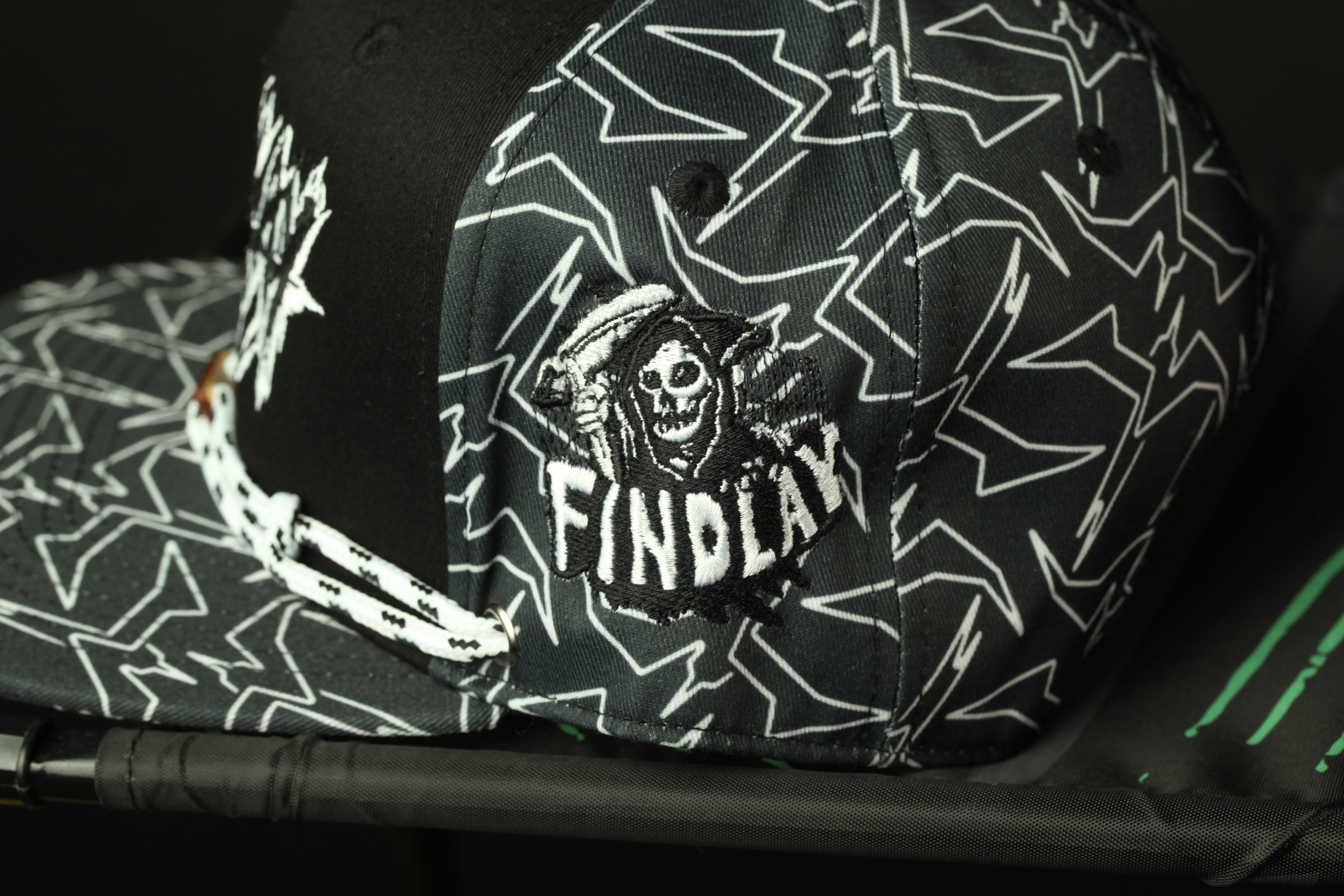A black and white patterned baseball cap with a skull and crossbones design.