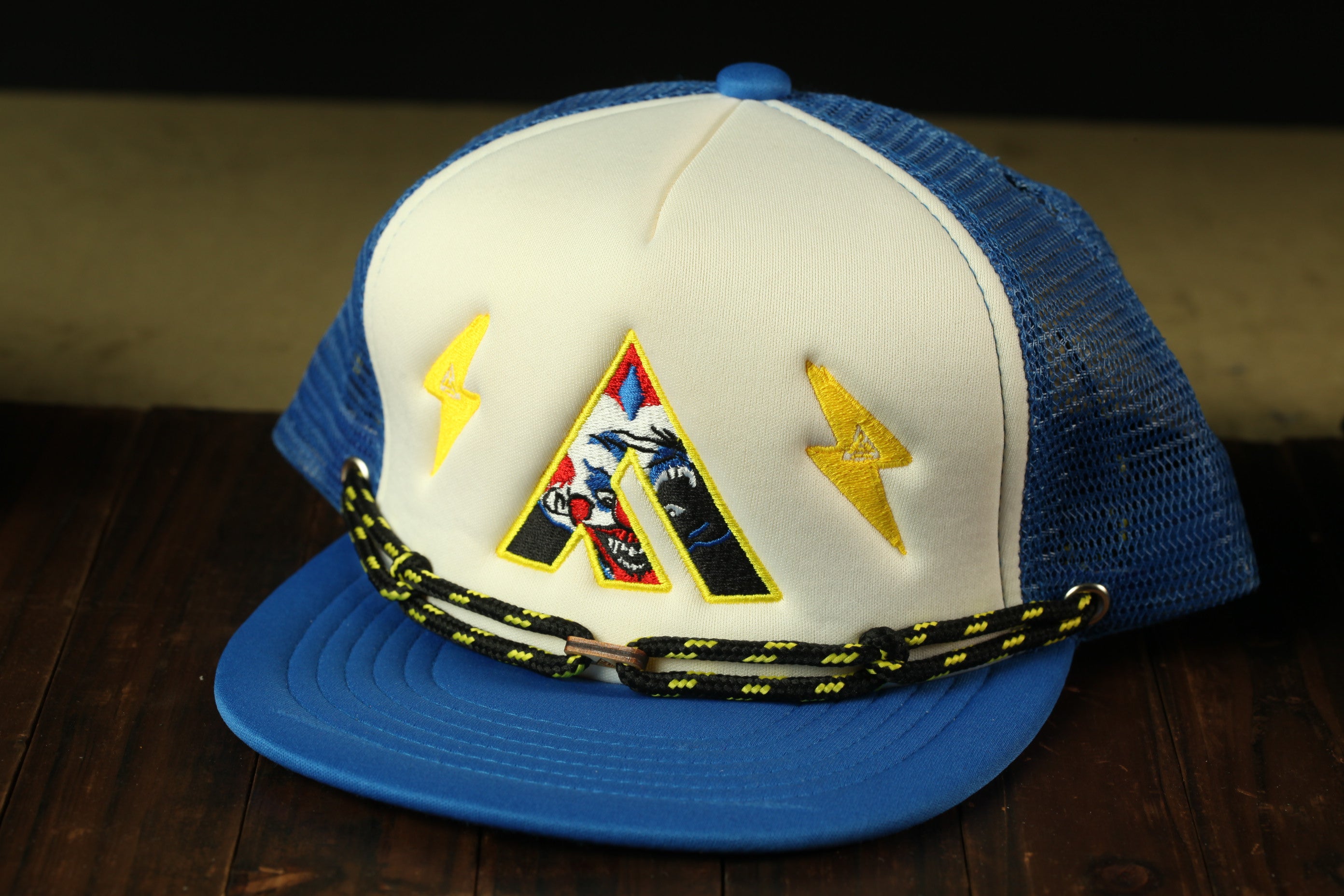 A blue and white baseball cap with a yellow lightning bolt design on the front.