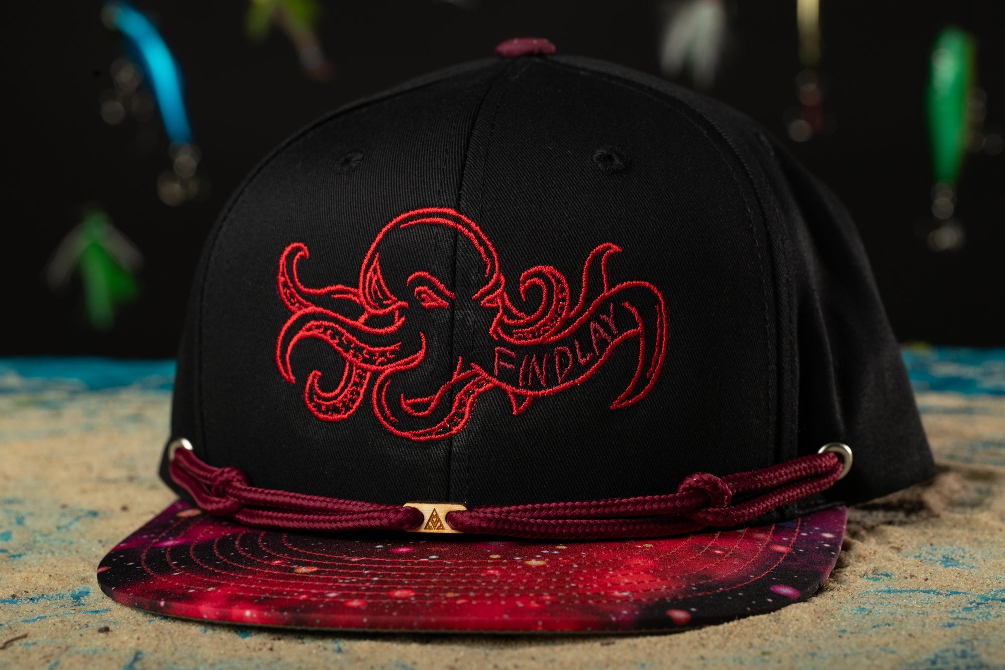 a black hat with a red octopus on it