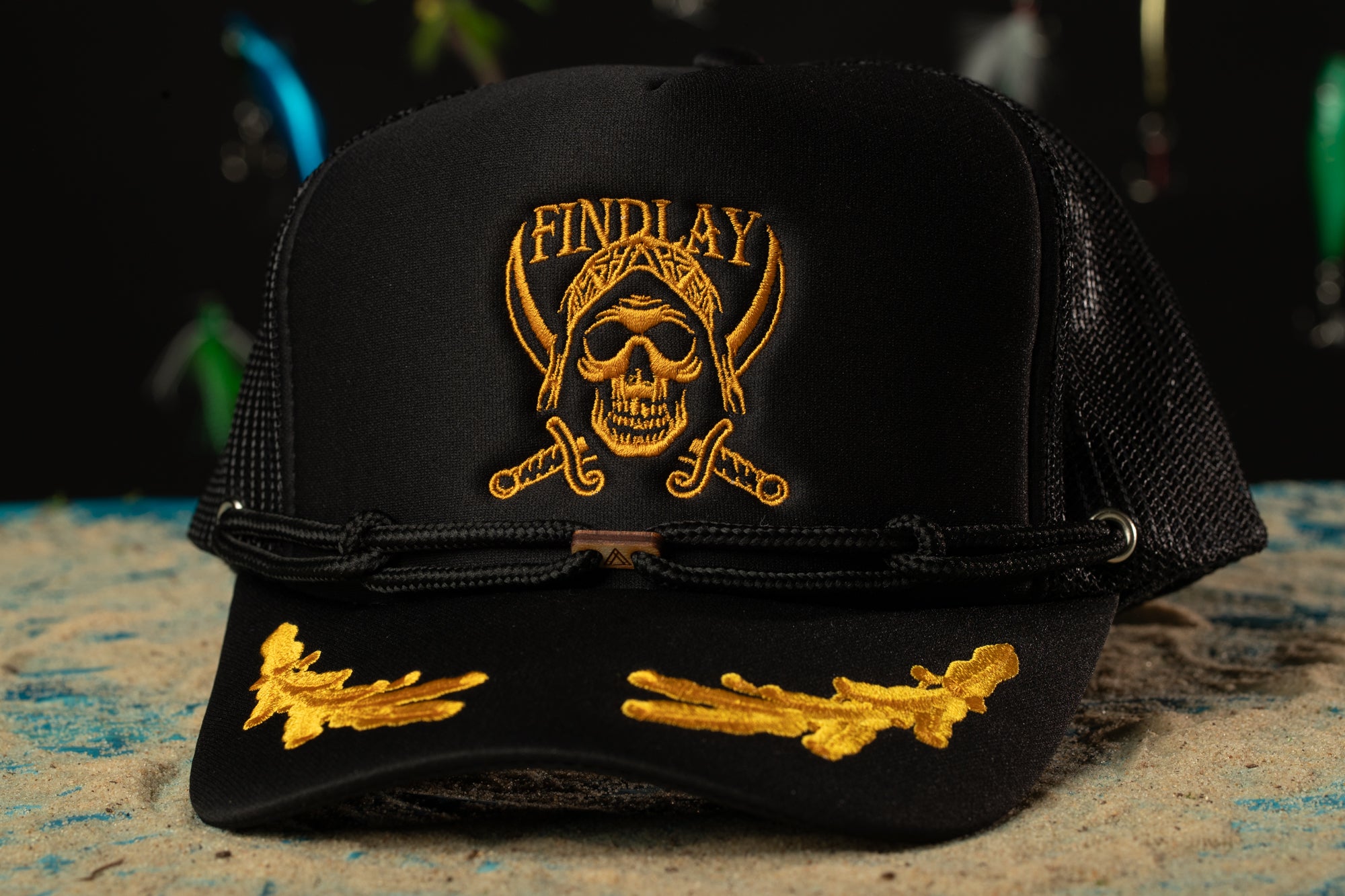 a black and gold hat with a skull on it
