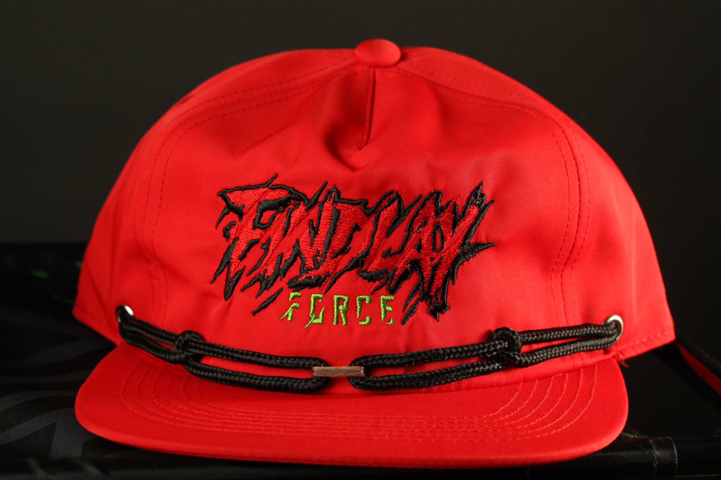 A red baseball cap with the text "FIND" and "FORCE" printed on it.