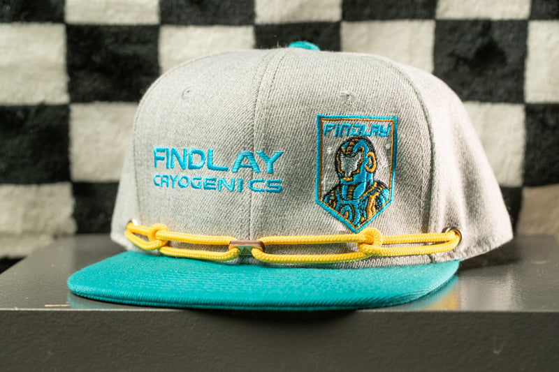 A gray baseball cap with a teal brim and yellow chain strap, featuring a logo on the front.