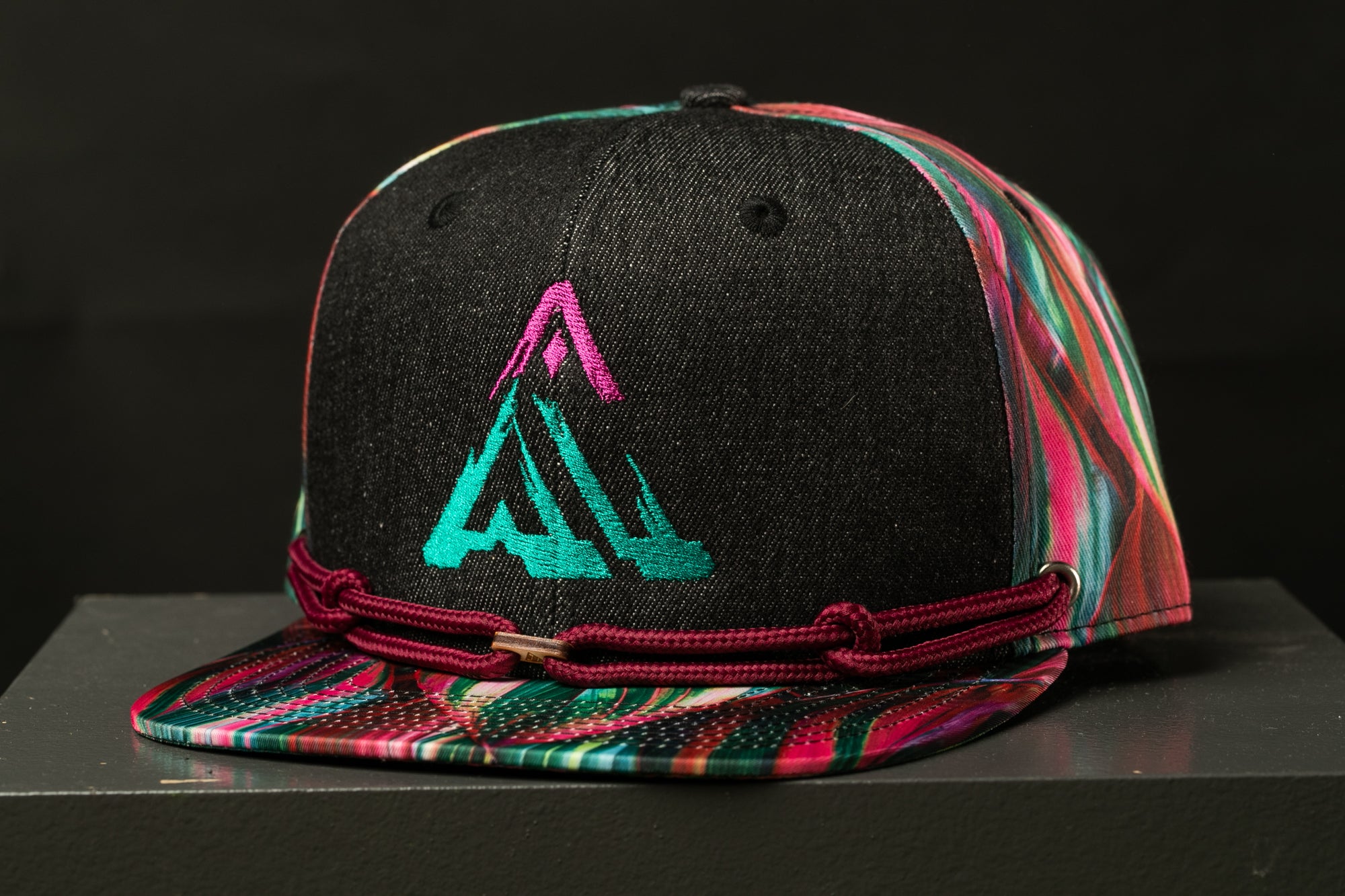 A colorful, patterned baseball cap with a graphic design on the front.