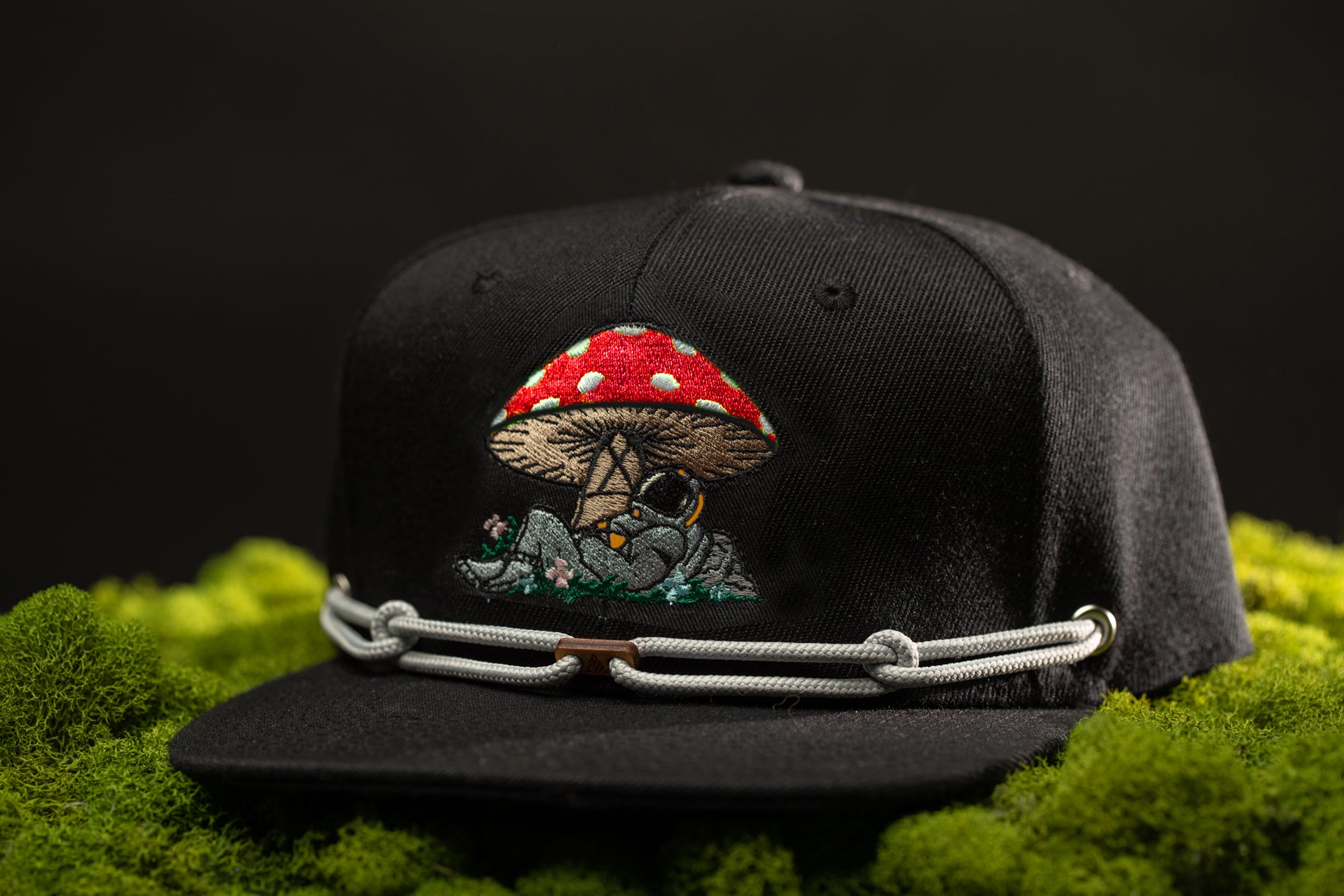 a black hat with a red mushroom on it