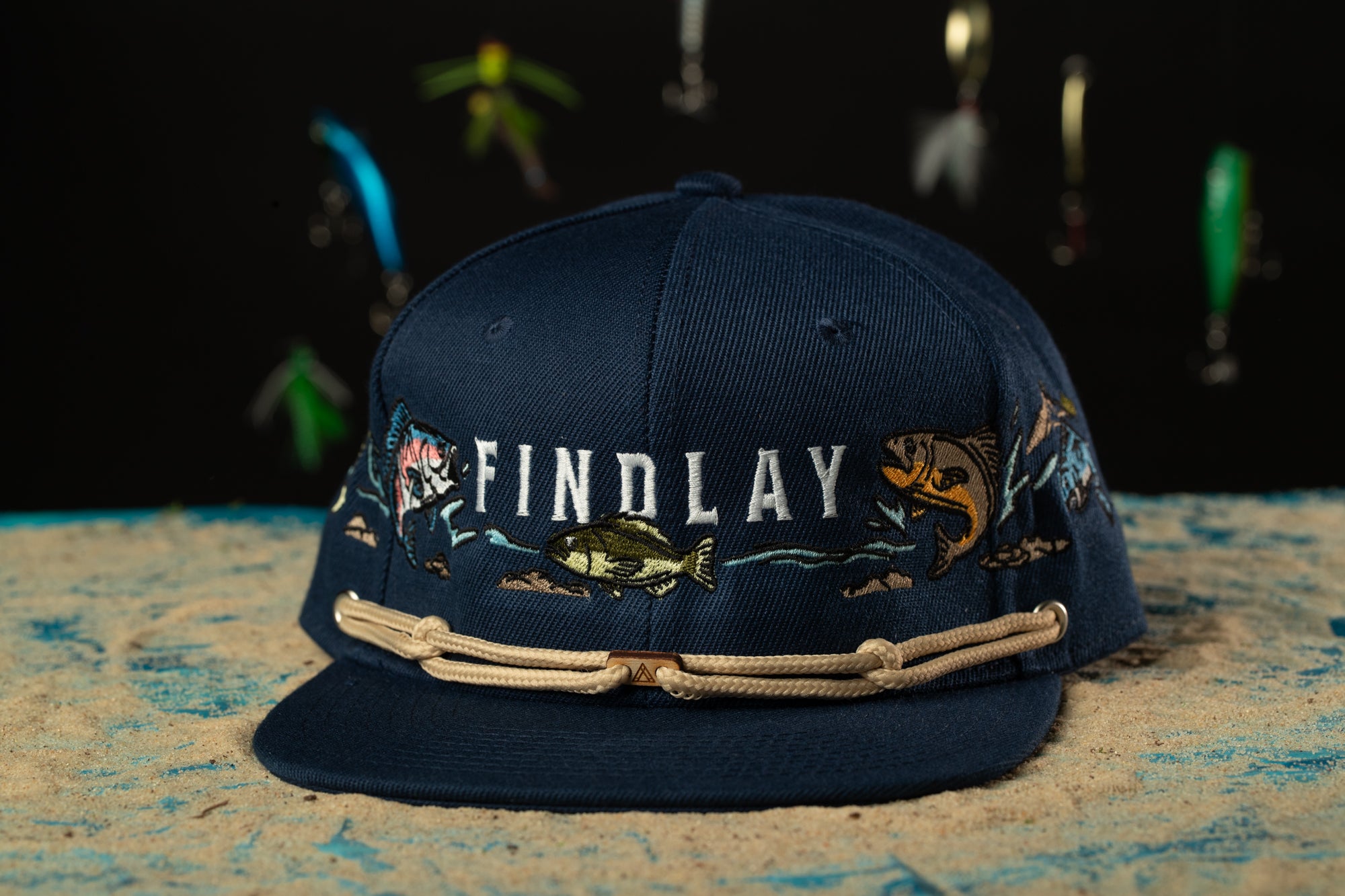 a blue hat with fish on it sitting on a table