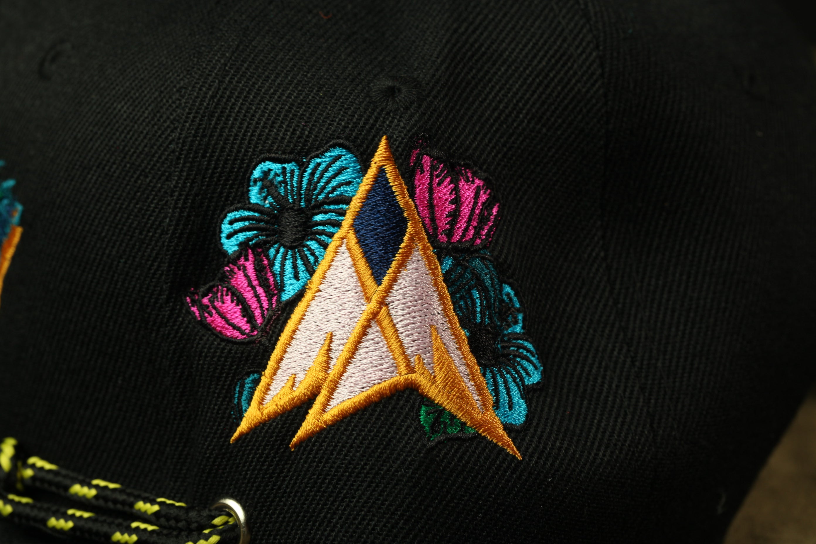 a close-up view of a black fabric with a colorful, embroidered design on it.