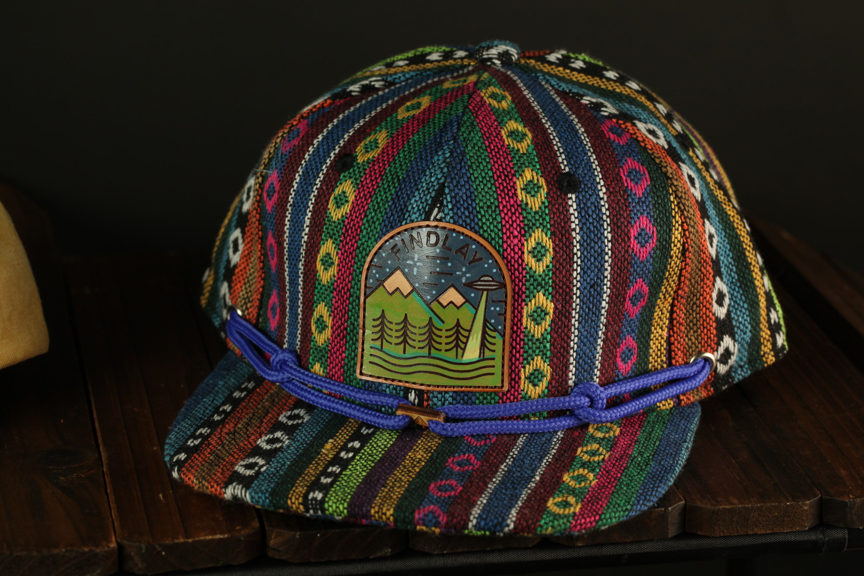 A colorful, patterned baseball cap with a unique design on the front.