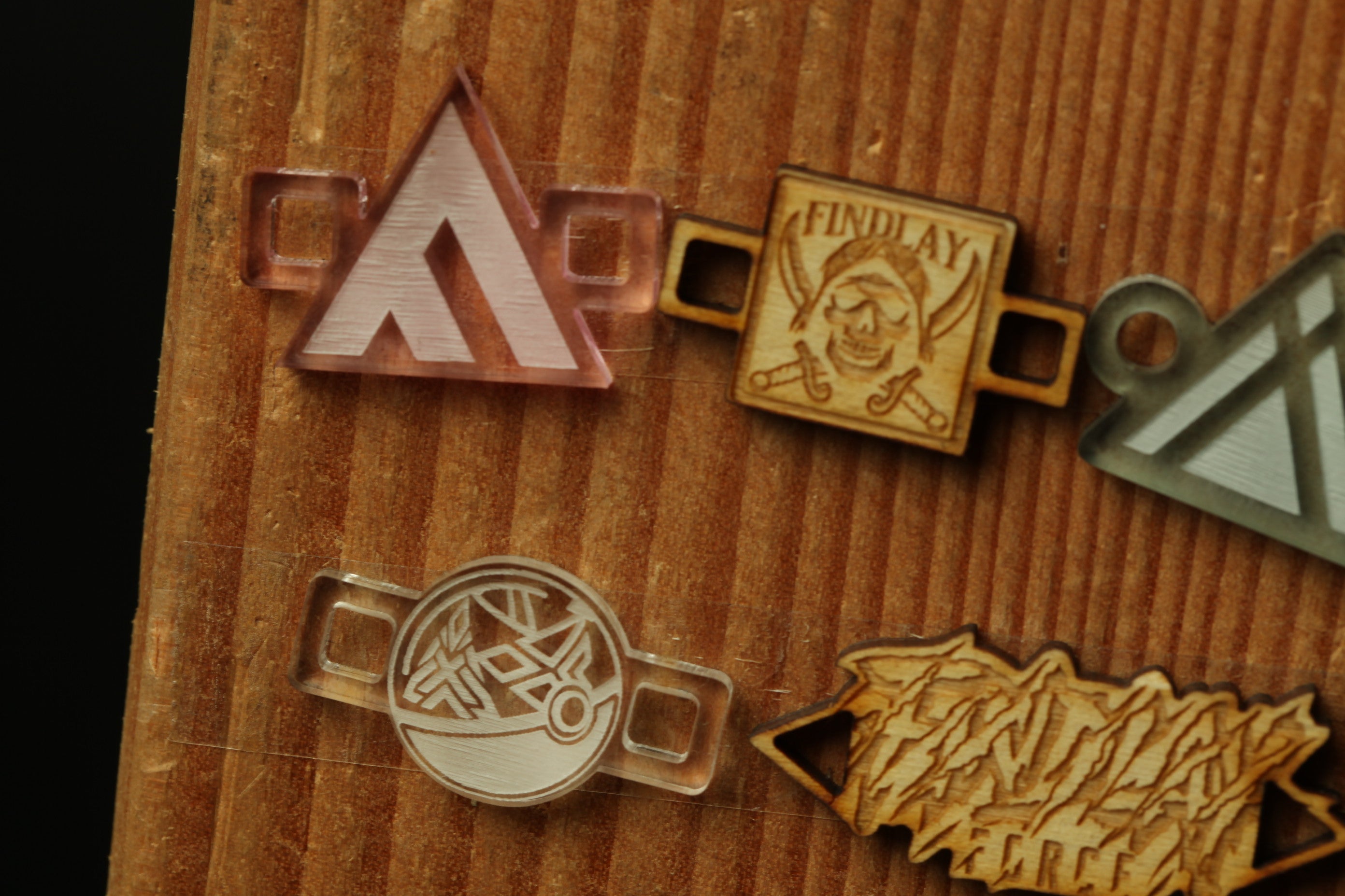 a variety of wooden and plastic objects, including a triangular object, a circular object, and a wooden object with a skull and crossbones design.