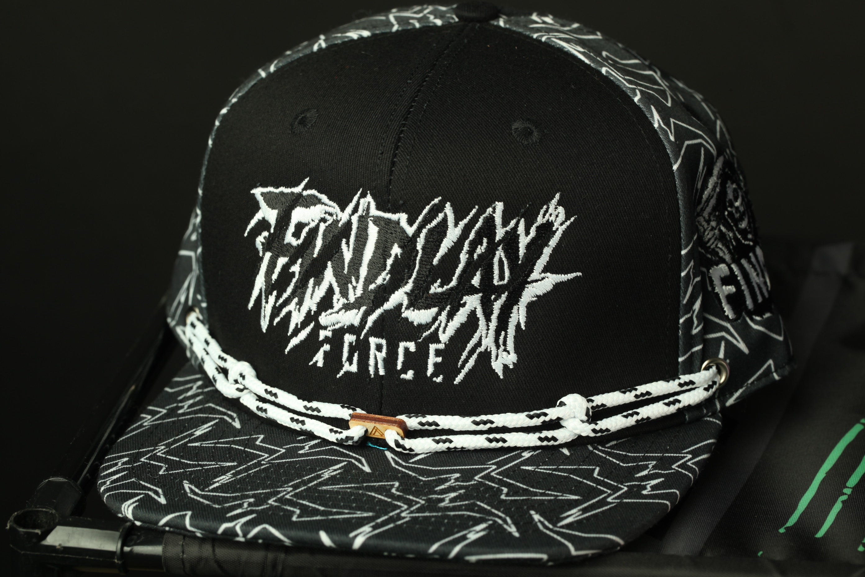 A black baseball cap with a white and black patterned design, featuring the text "FENDY FORCE" on the front.