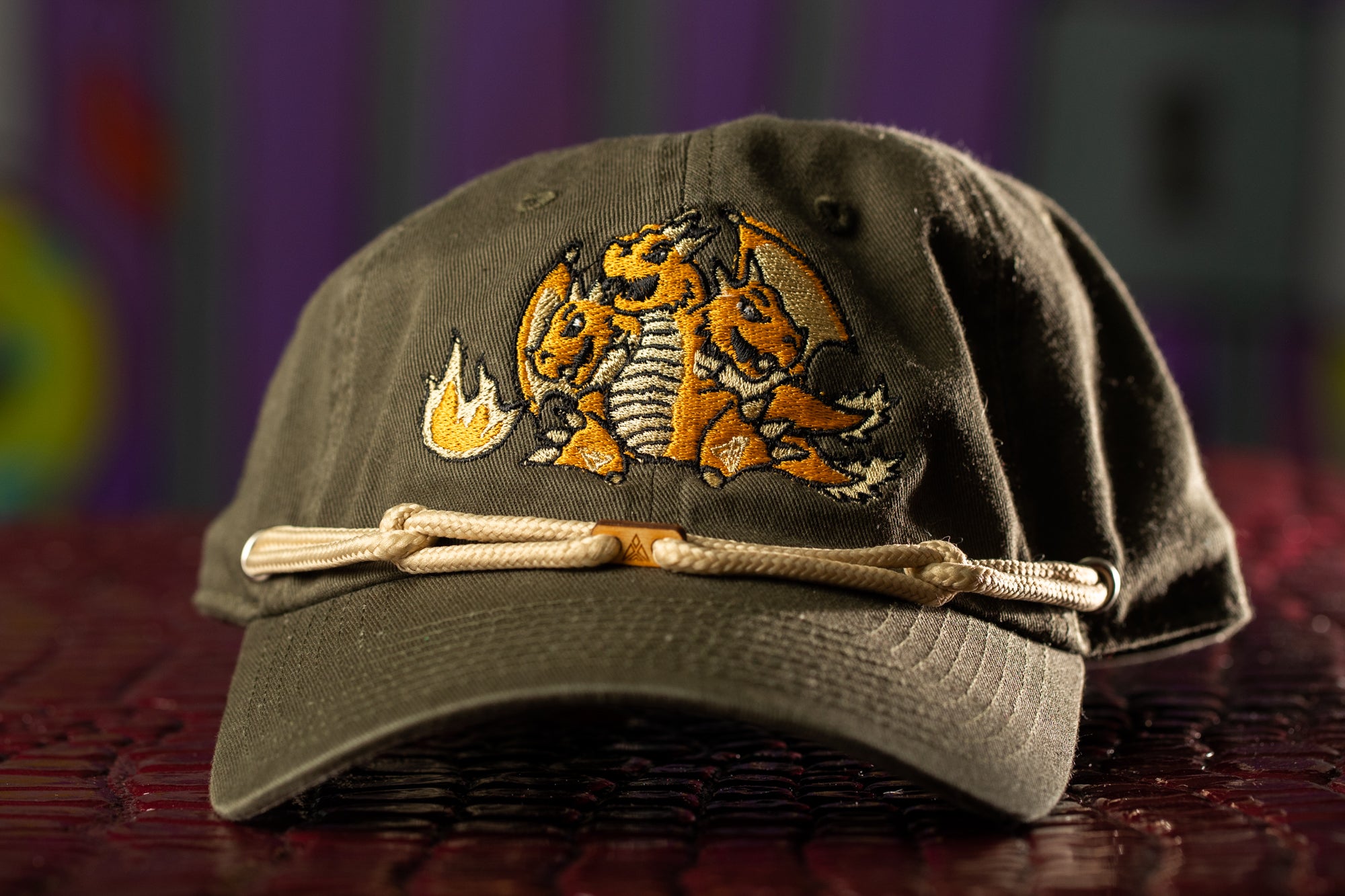 a hat with a dragon embroidered on it