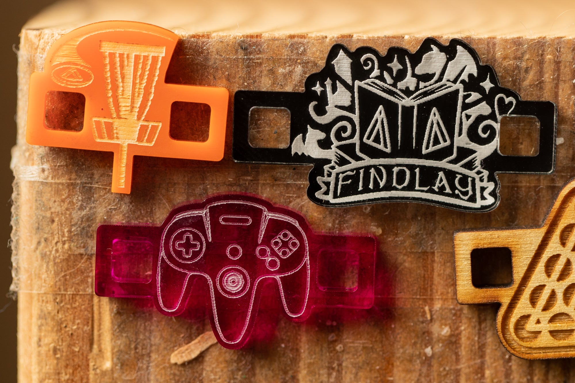 a collection of colorful plastic or wooden objects, including a frisbee, a video game controller, and a wooden block, all attached to a wooden surface.