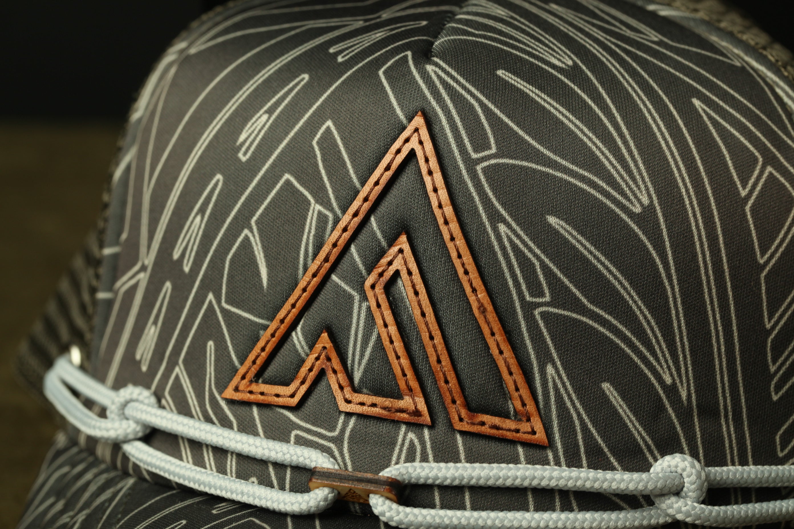 a close-up view of a gray fabric with a distinctive orange triangle logo on it.