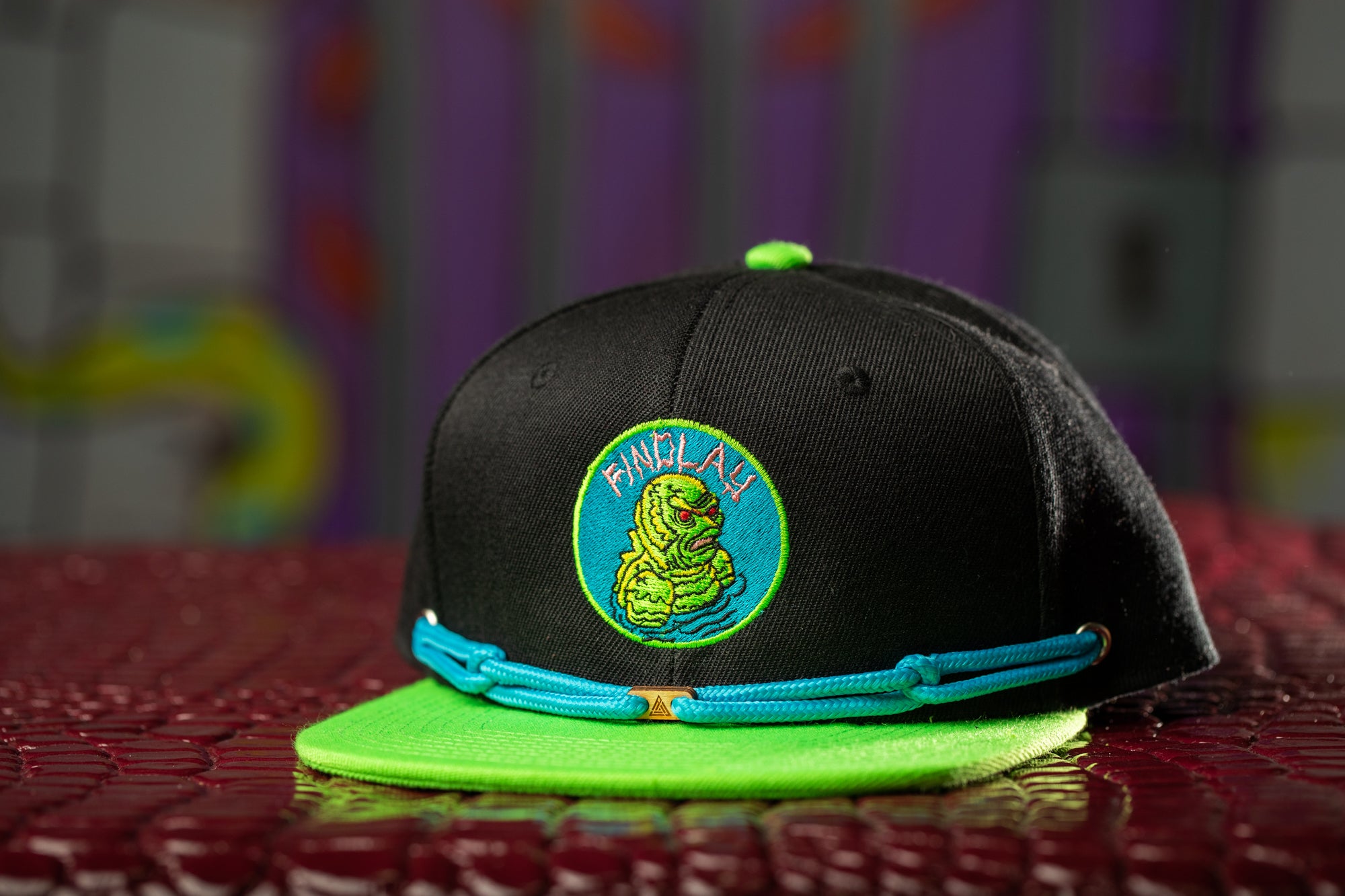 a black and green hat sitting on top of a table