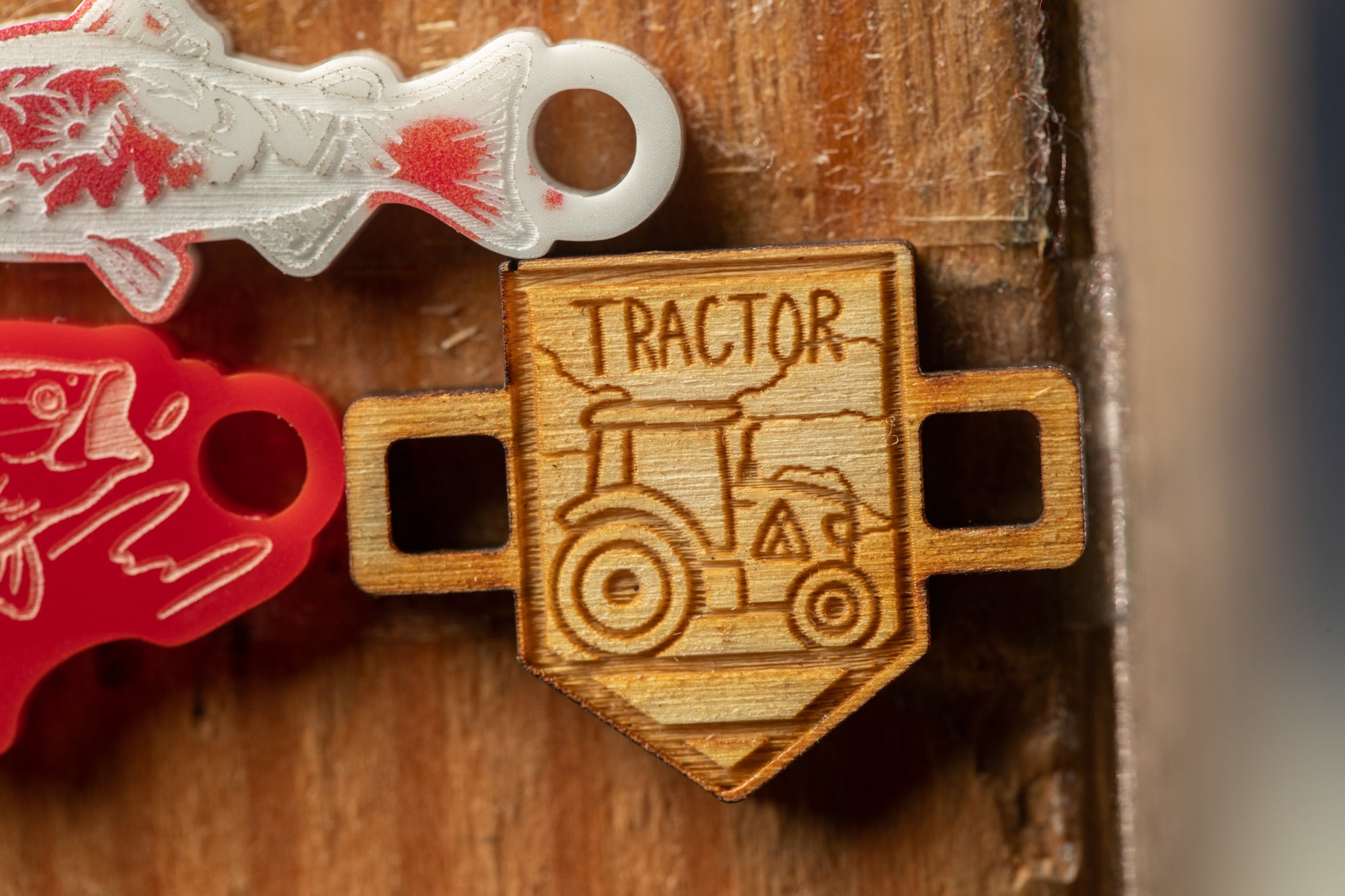 a wooden object with a tractor design, placed on a wooden surface.