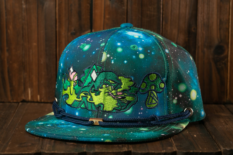A colorful, patterned baseball cap with a space-themed design, featuring a mushroom and various celestial elements.