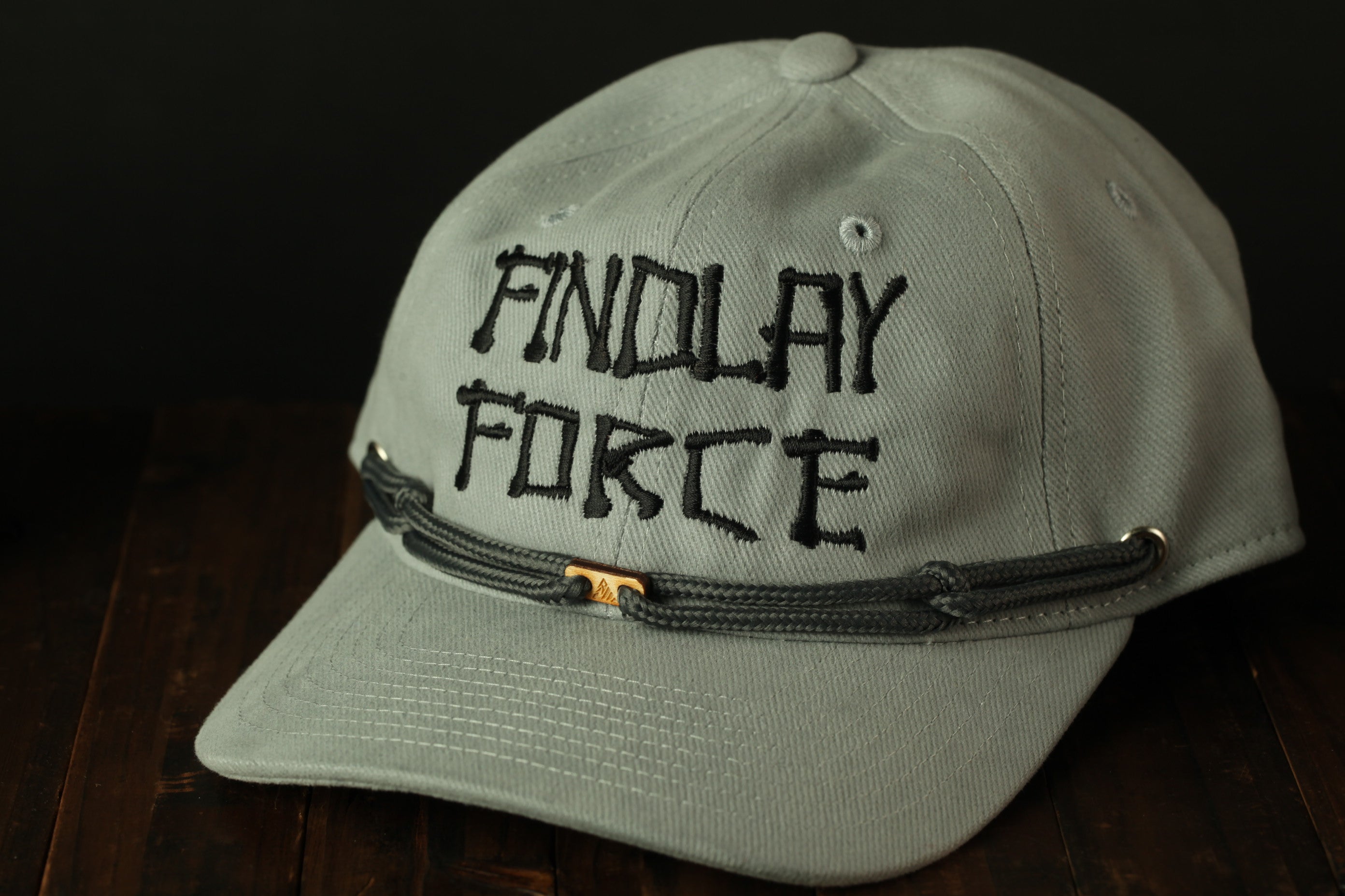 A gray baseball cap with the text "FINDOLAY FORCE" printed on it.