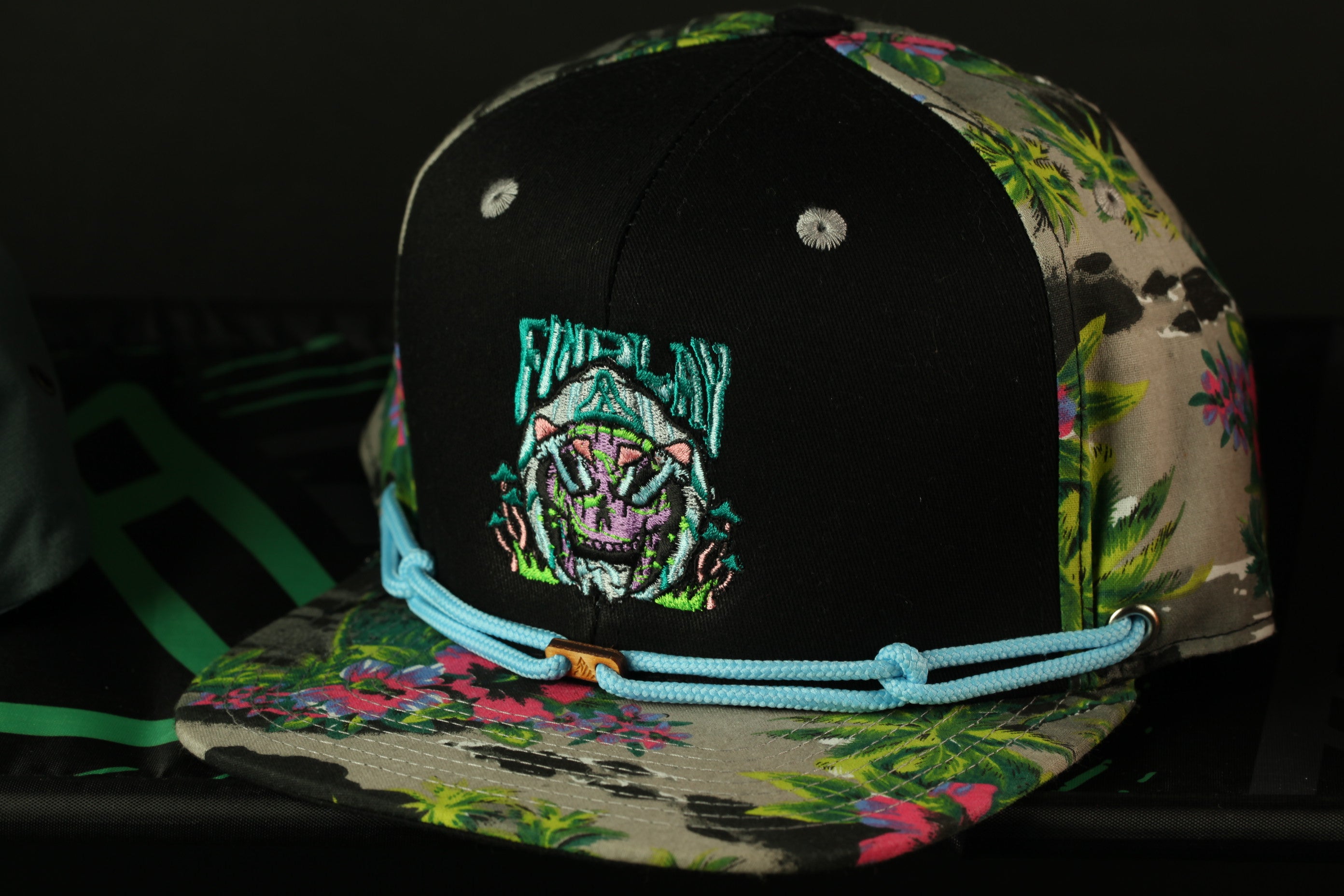 A colorful, patterned baseball cap with a graphic design on the front.