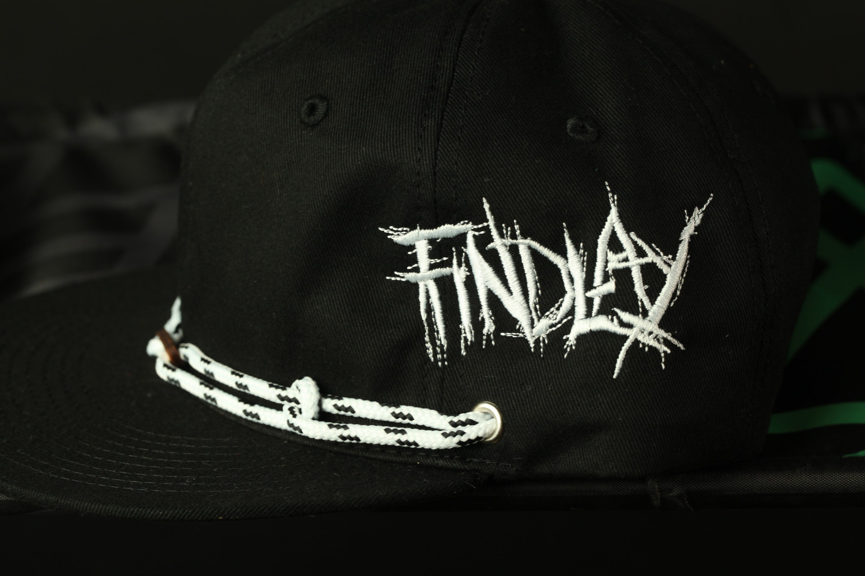 A black baseball cap with white text on it.